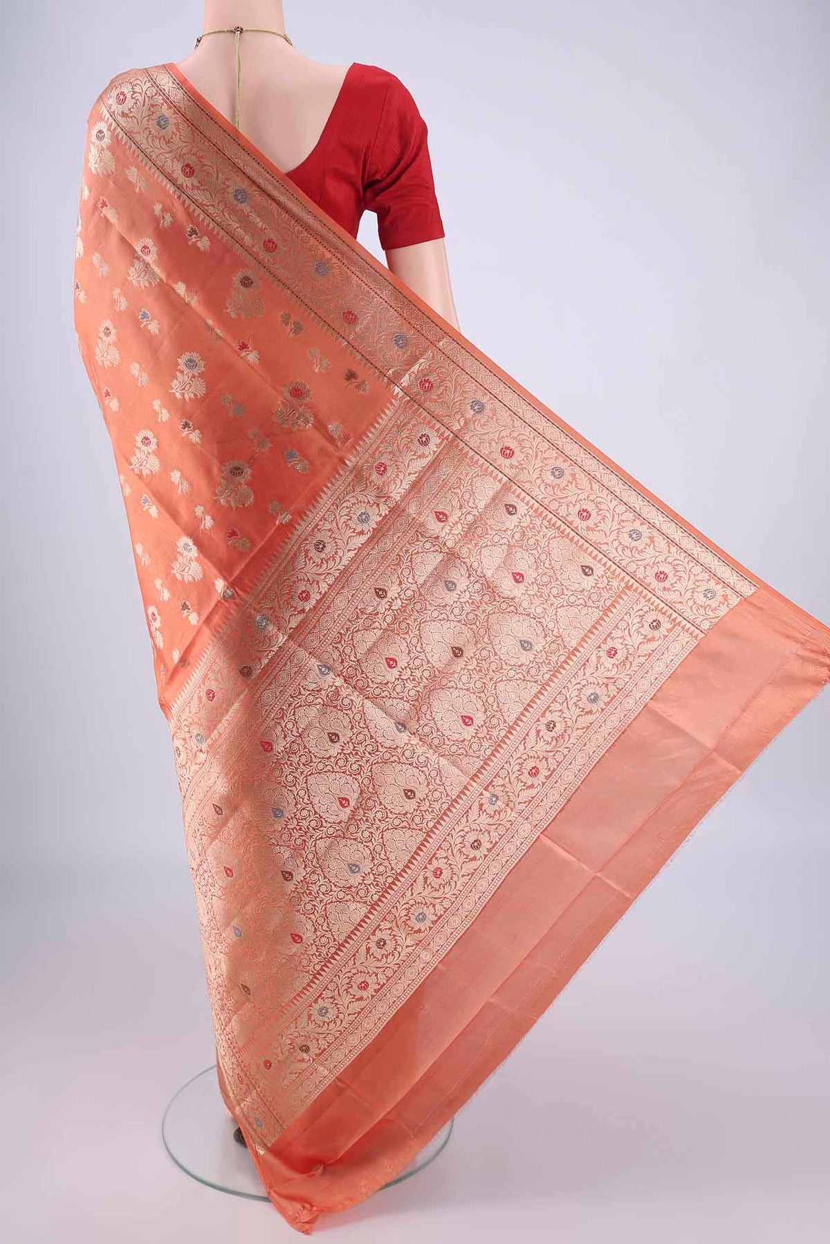 Flat view of Peach Banarasi Raw Silk Saree with Zari And Thread Butta on the body and Zari Border. 