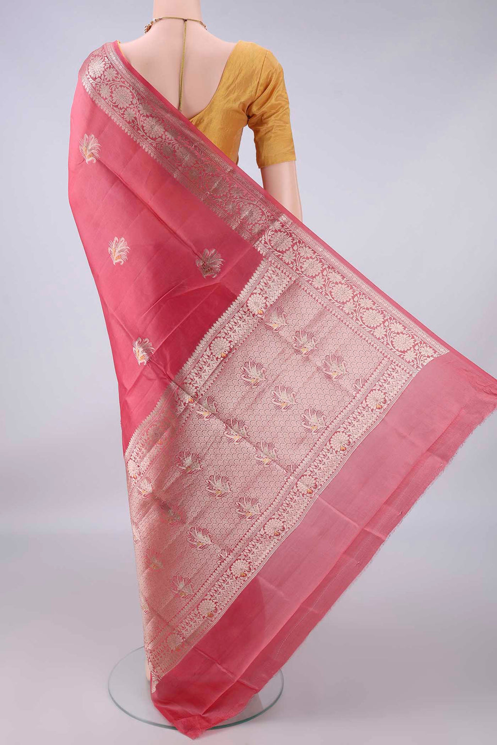Flat view of Pure Silk Coral Banarasi Raw Saree with Zari Butta on the body and Zari And Thread Border. 
