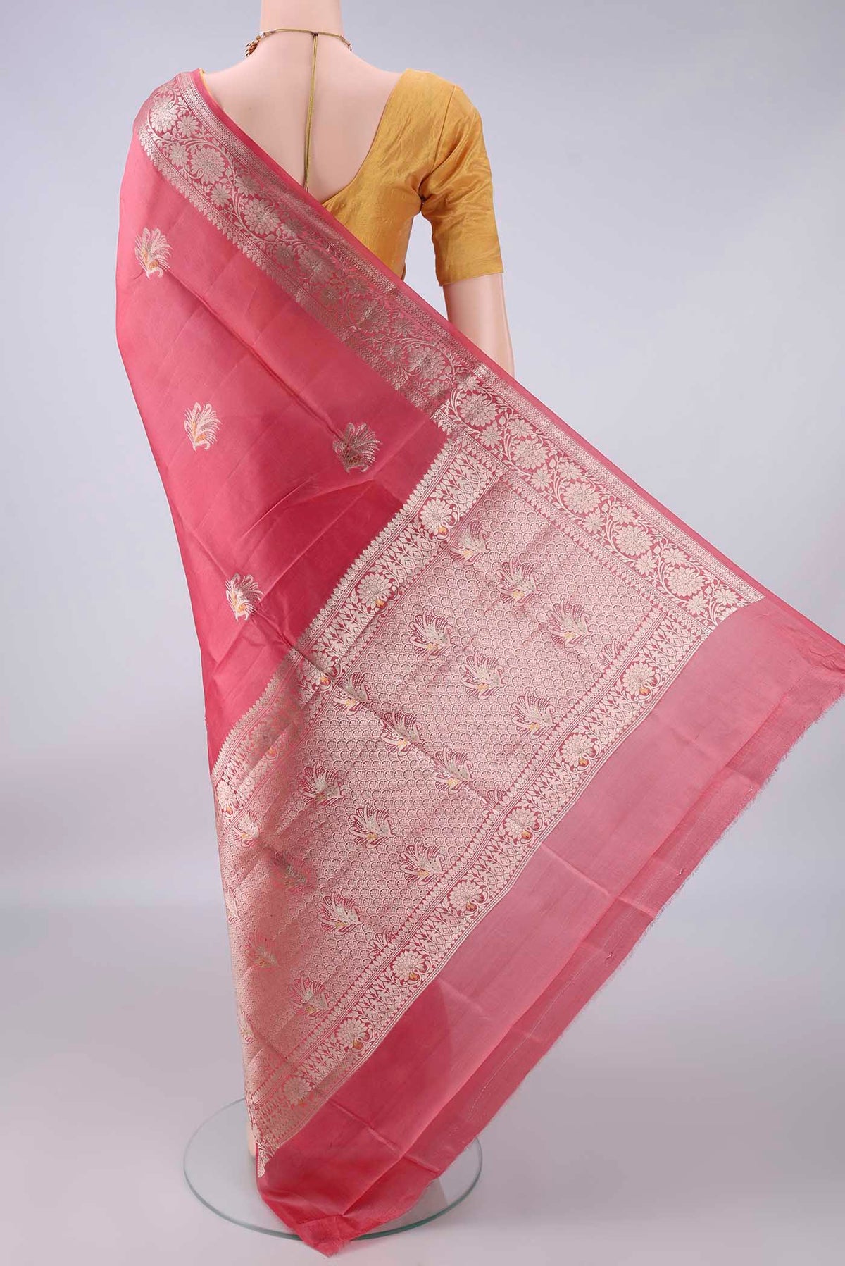 Flat view of Pure Silk Coral Banarasi Raw Saree with Zari Butta on the body and Zari And Thread Border. 