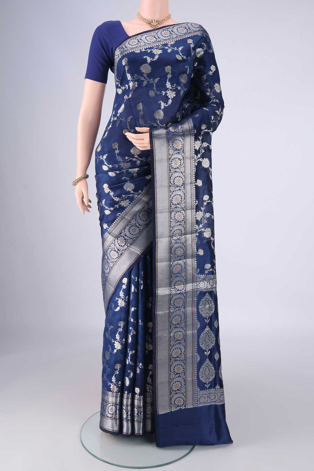 Dark Blue Banarasi Raw Silk Saree with Zari Brocade on the body and Zari Border.  displayed on a mannequin