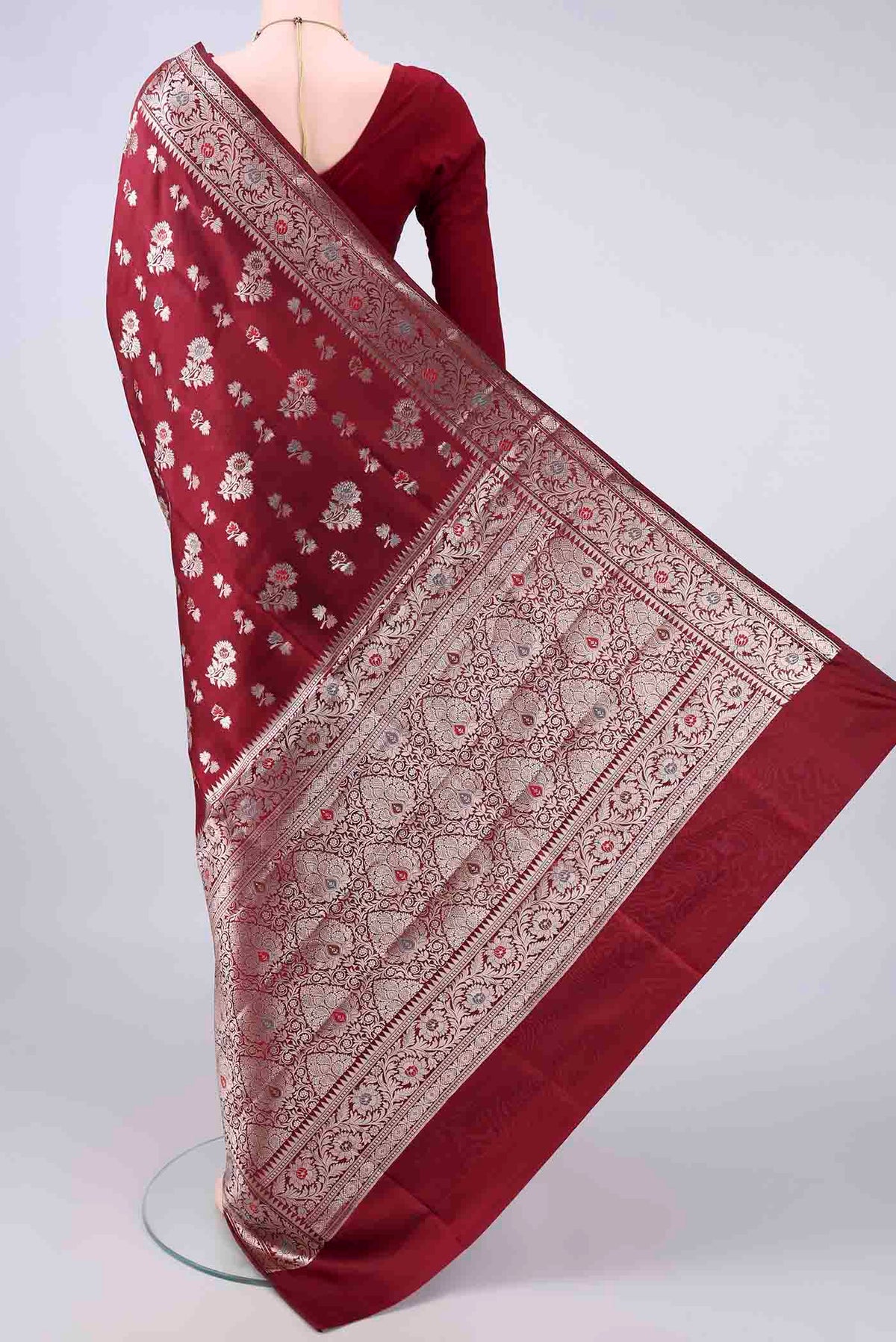 Flat view of Pure Silk Maroon Banarasi Raw Saree with Zari Butta on the body and Zari Border. 