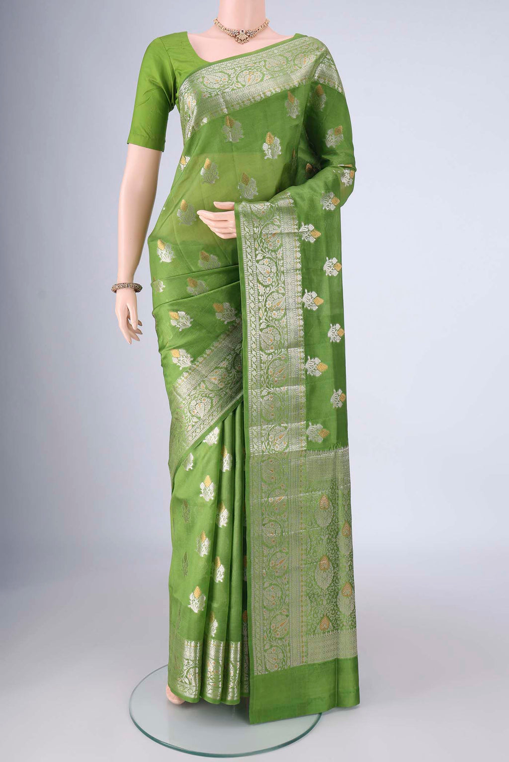 Green Banarasi Tussar Silk Saree with Zari Butta on the body and Zari Border.  displayed on a mannequin