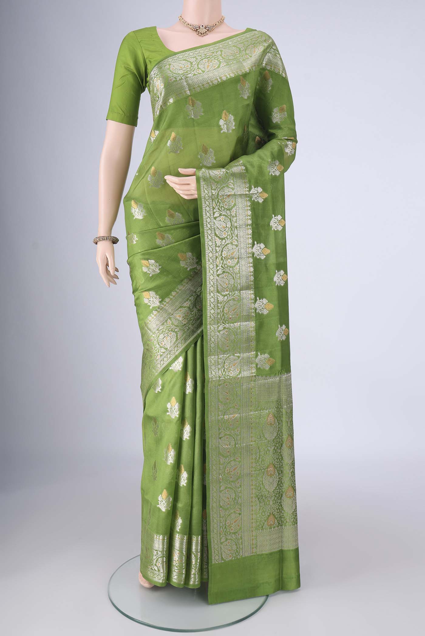 Green Banarasi Tussar Silk Saree with Zari Butta on the body and Zari Border.  displayed on a mannequin