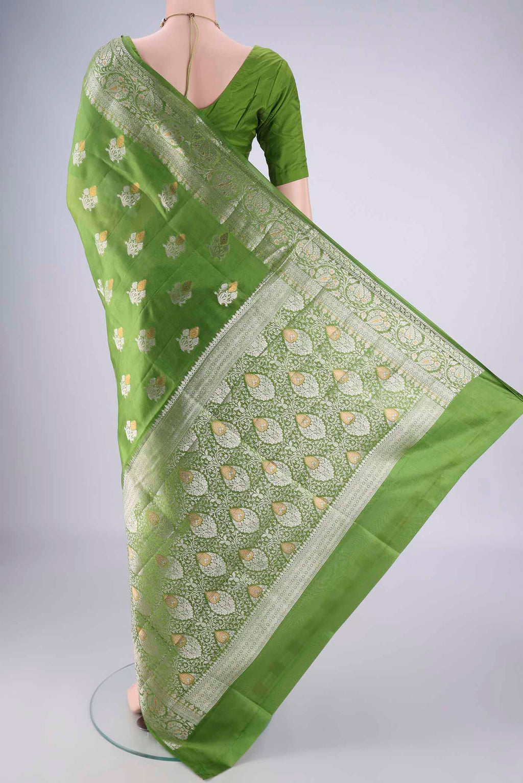 Flat view of Green Banarasi Tussar Silk Saree with Zari Butta on the body and Zari Border. 