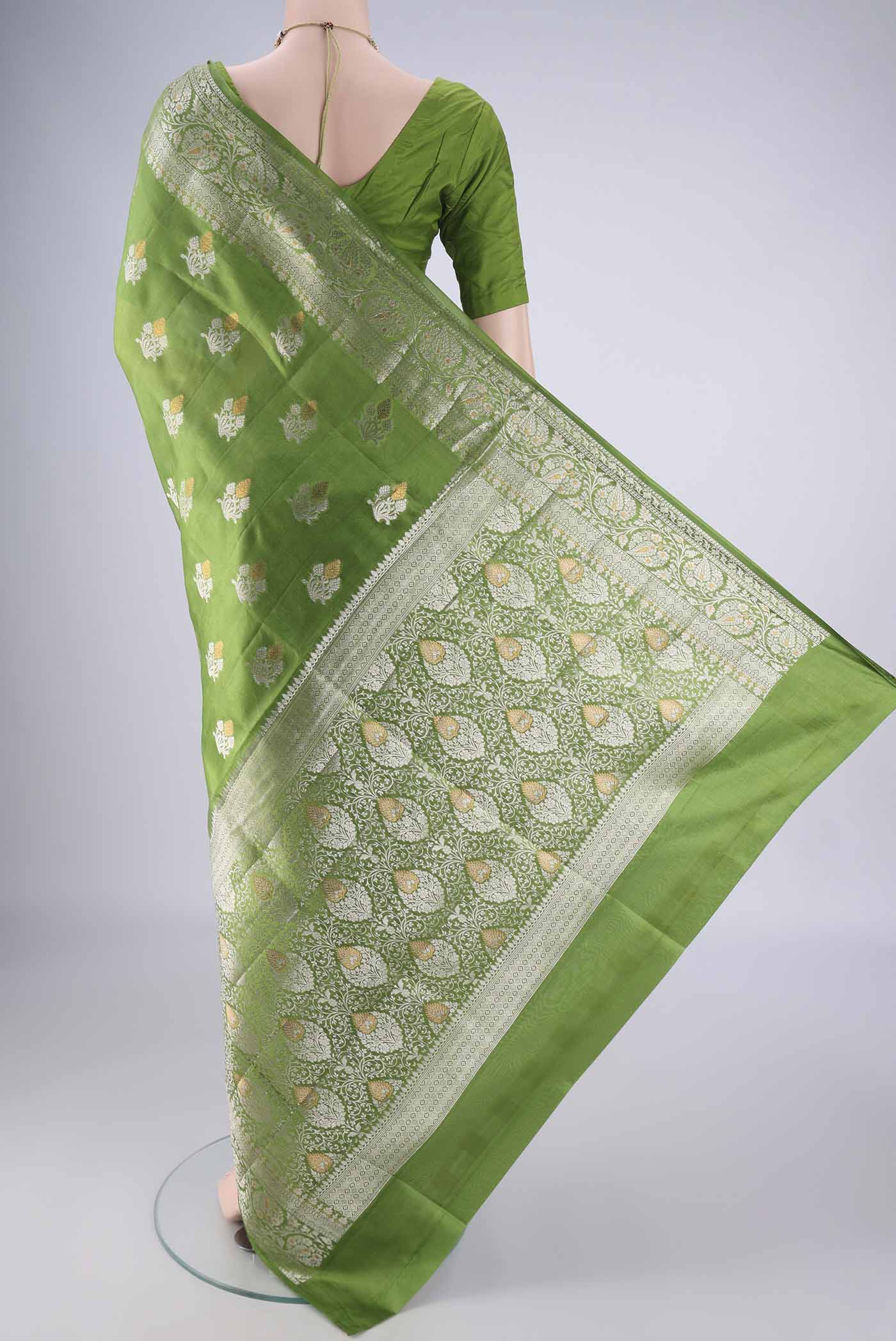 Flat view of Green Banarasi Tussar Silk Saree with Zari Butta on the body and Zari Border. 