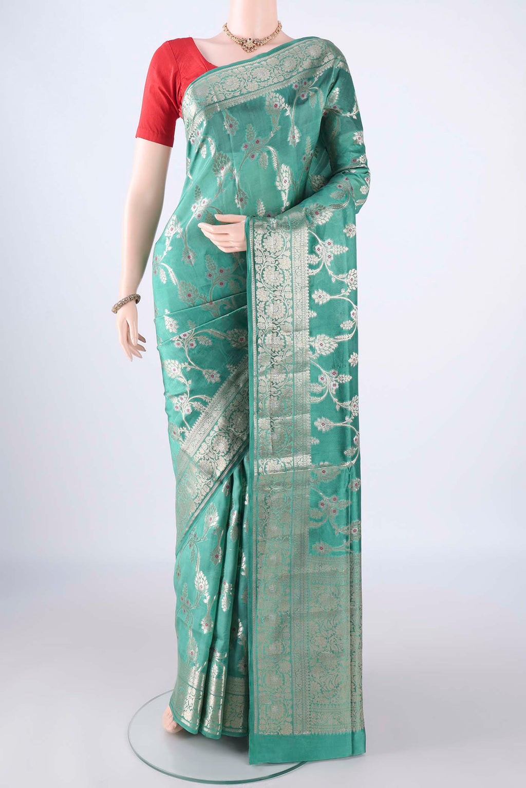 Turquoise Banarasi Tussar Silk Saree with Zari And Thread Butta on the body and Zari Border.  displayed on a mannequin