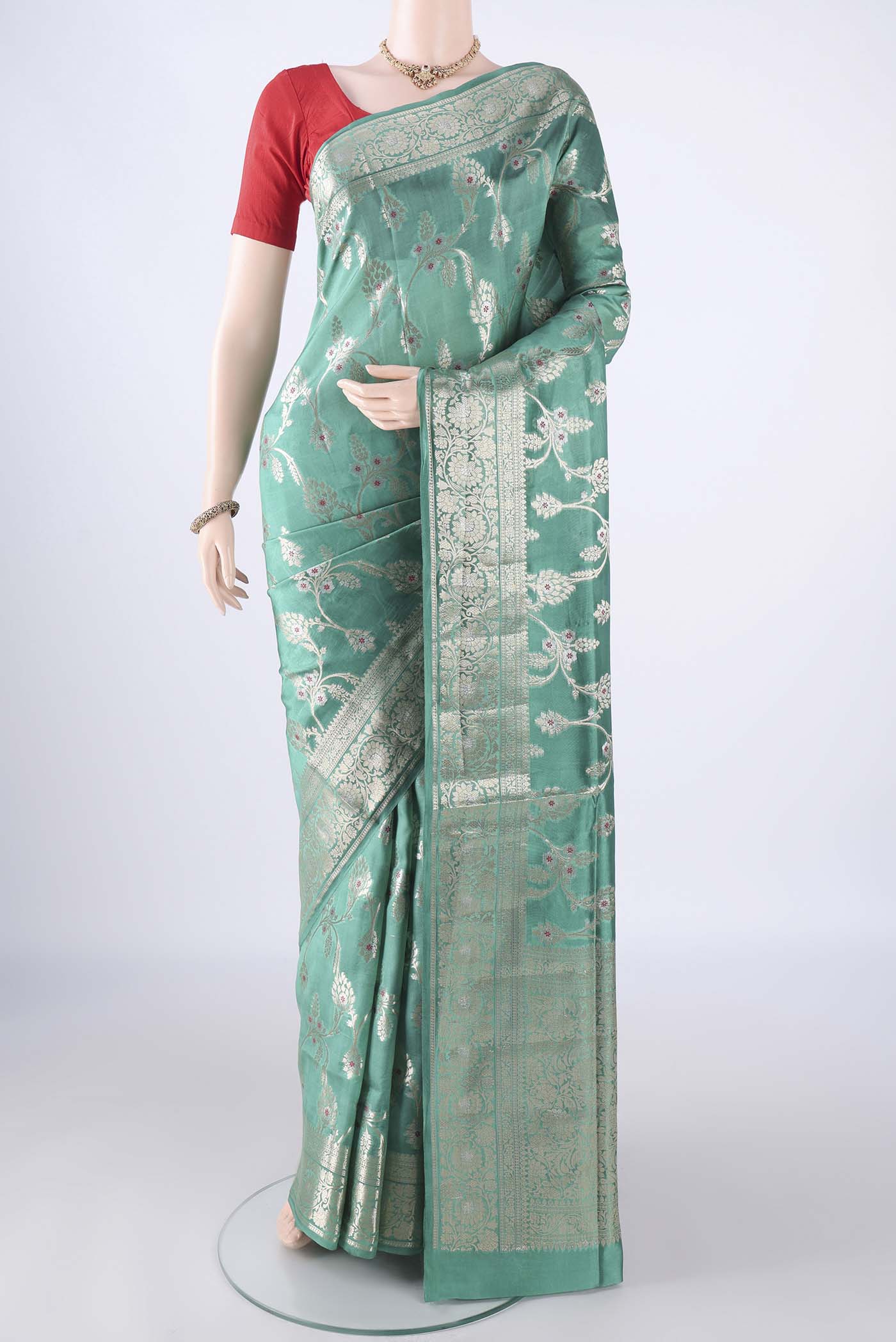 Turquoise Banarasi Tussar Silk Saree with Zari And Thread Butta on the body and Zari Border.  displayed on a mannequin