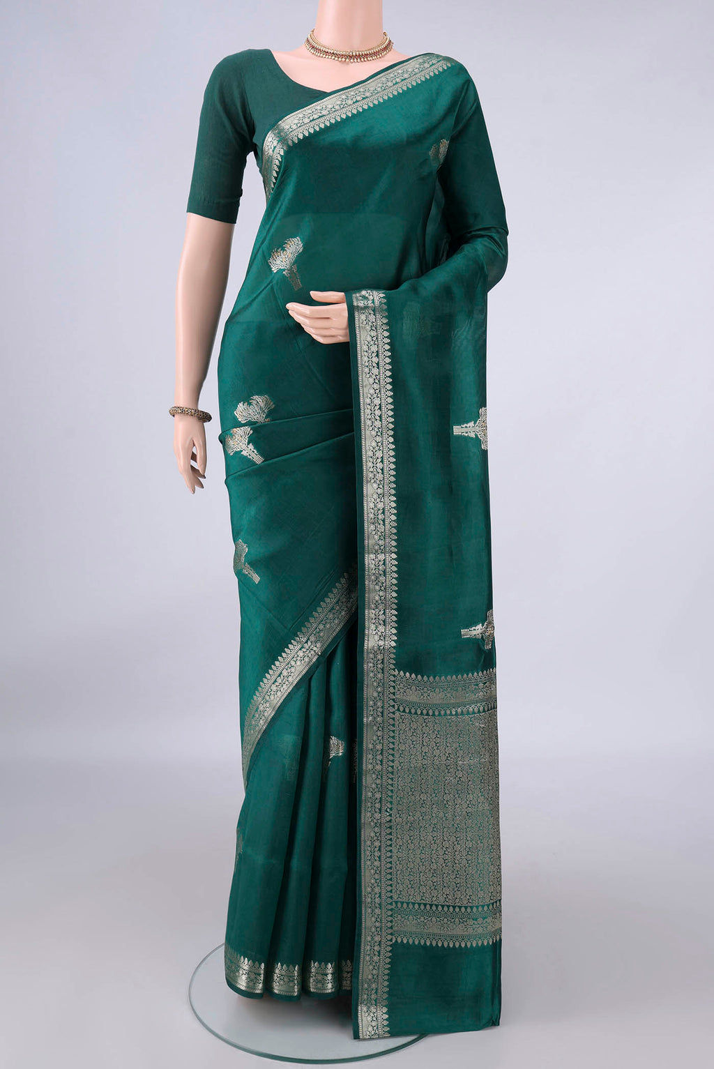 Pure Silk Sea Green Banarasi Raw Saree with Zari Butta on the body and Zari Border.  displayed on a mannequin