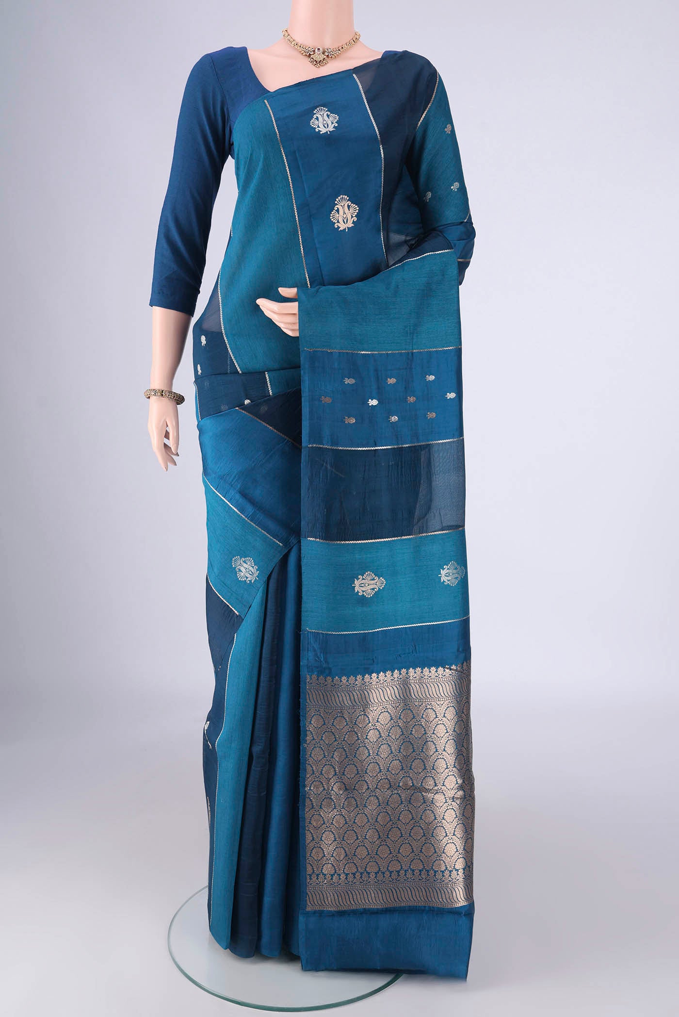 Blue Banarasi Katan Silk Saree with Stripes on the body and Without Border.  displayed on a mannequin