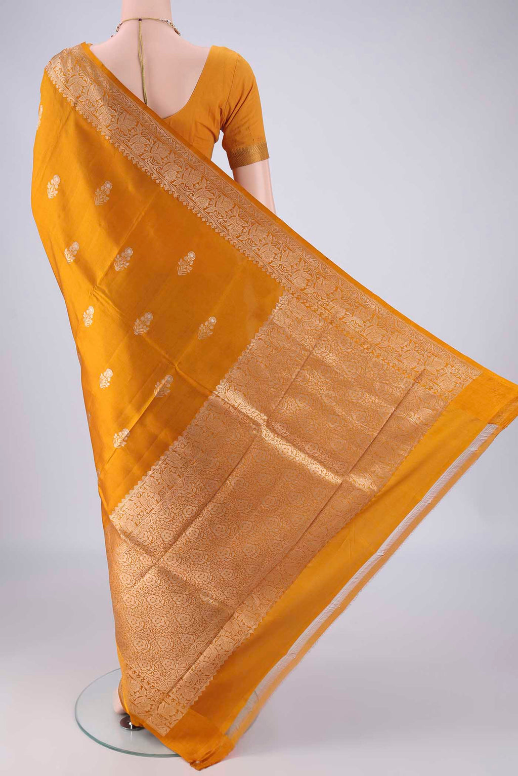 Flat view of Mustard Banarasi Katan Silk Saree with Zari Butta on the body and Zari Border. 