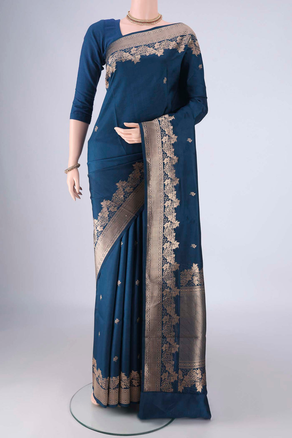 Blue Banarasi Katan Silk Saree with Zari Butta on the body and Zari Border.  displayed on a mannequin