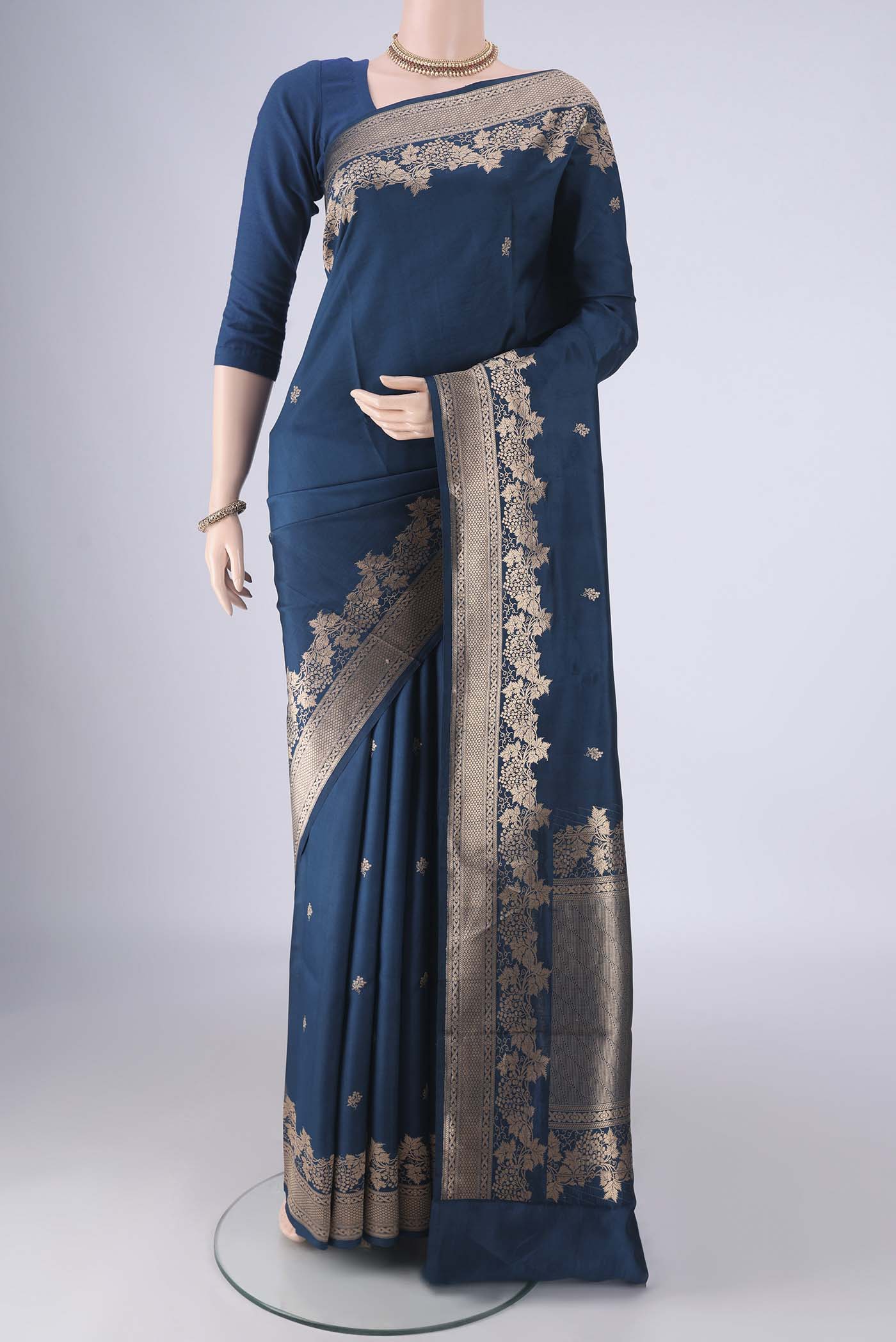 Blue Banarasi Katan Silk Saree with Zari Butta on the body and Zari Border.  displayed on a mannequin