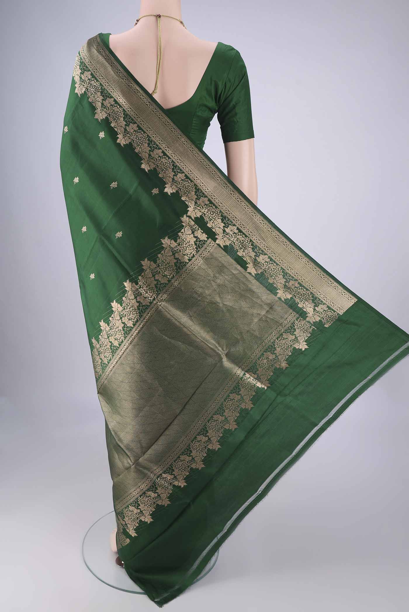 Flat view of Bottle Green Banarasi Katan Silk Saree with Zari Butta on the body and Zari Border. 