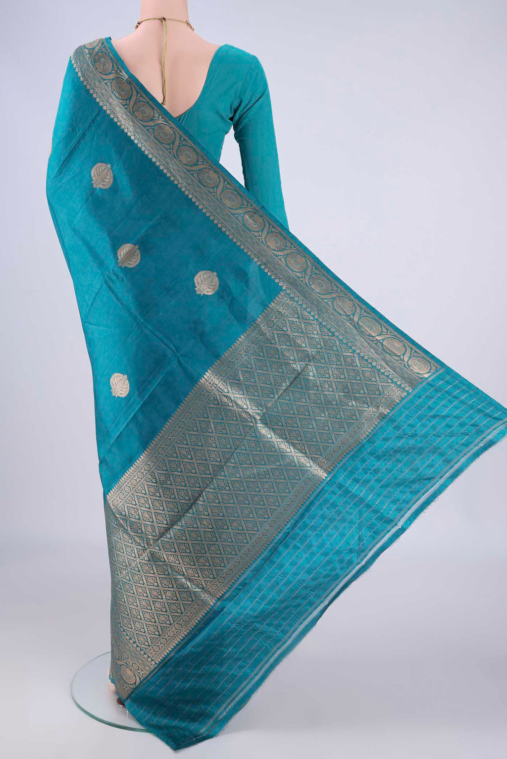 Flat view of Blue Banarasi Katan Silk Saree with Zari Butta on the body and Zari Border. 