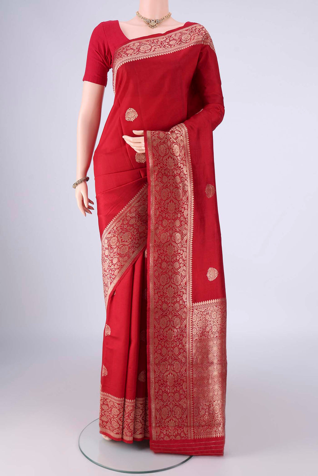 Red Banarasi Katan Silk Saree with Zari Butta on the body and Zari Border.  displayed on a mannequin