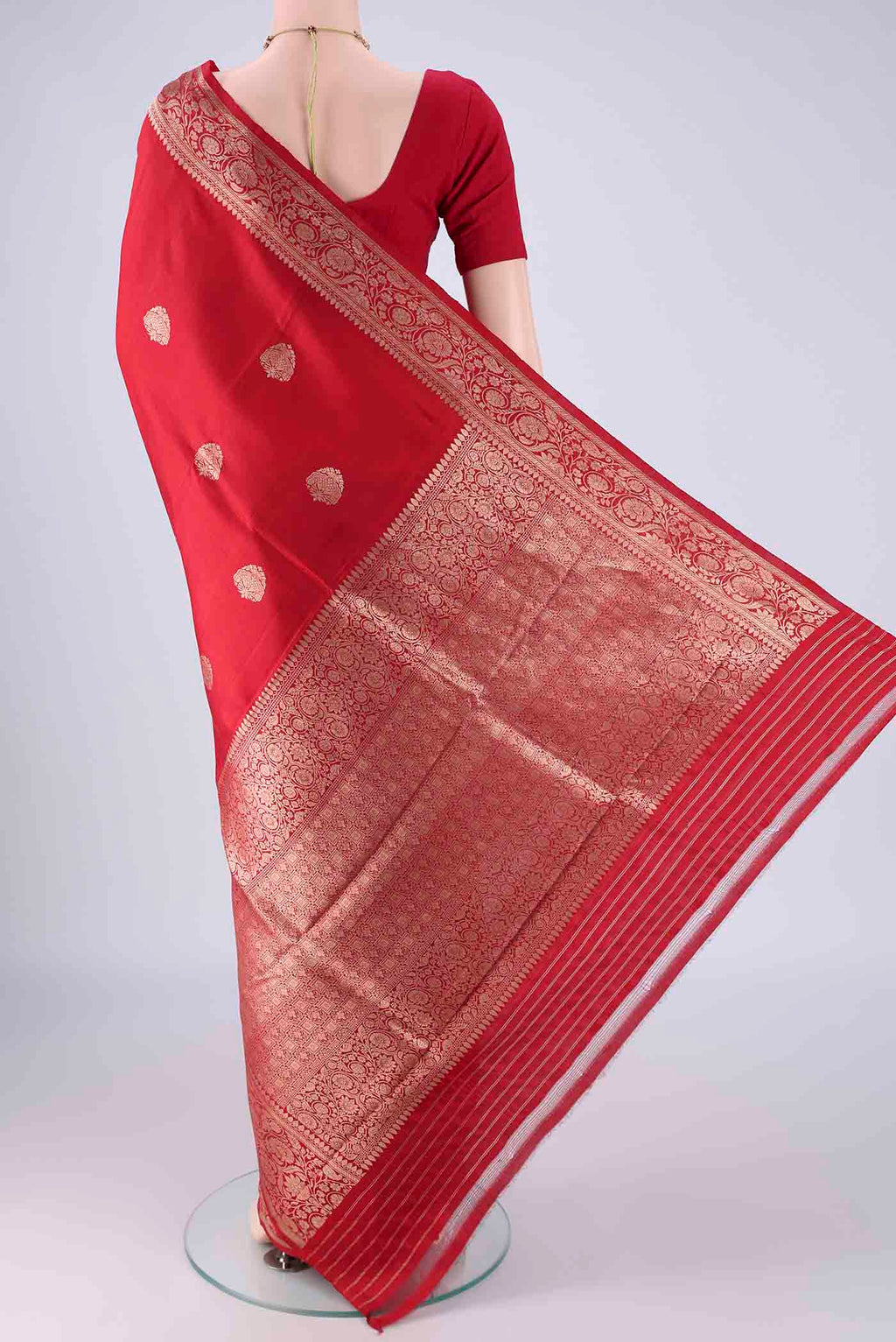 Flat view of Red Banarasi Katan Silk Saree with Zari Butta on the body and Zari Border. 