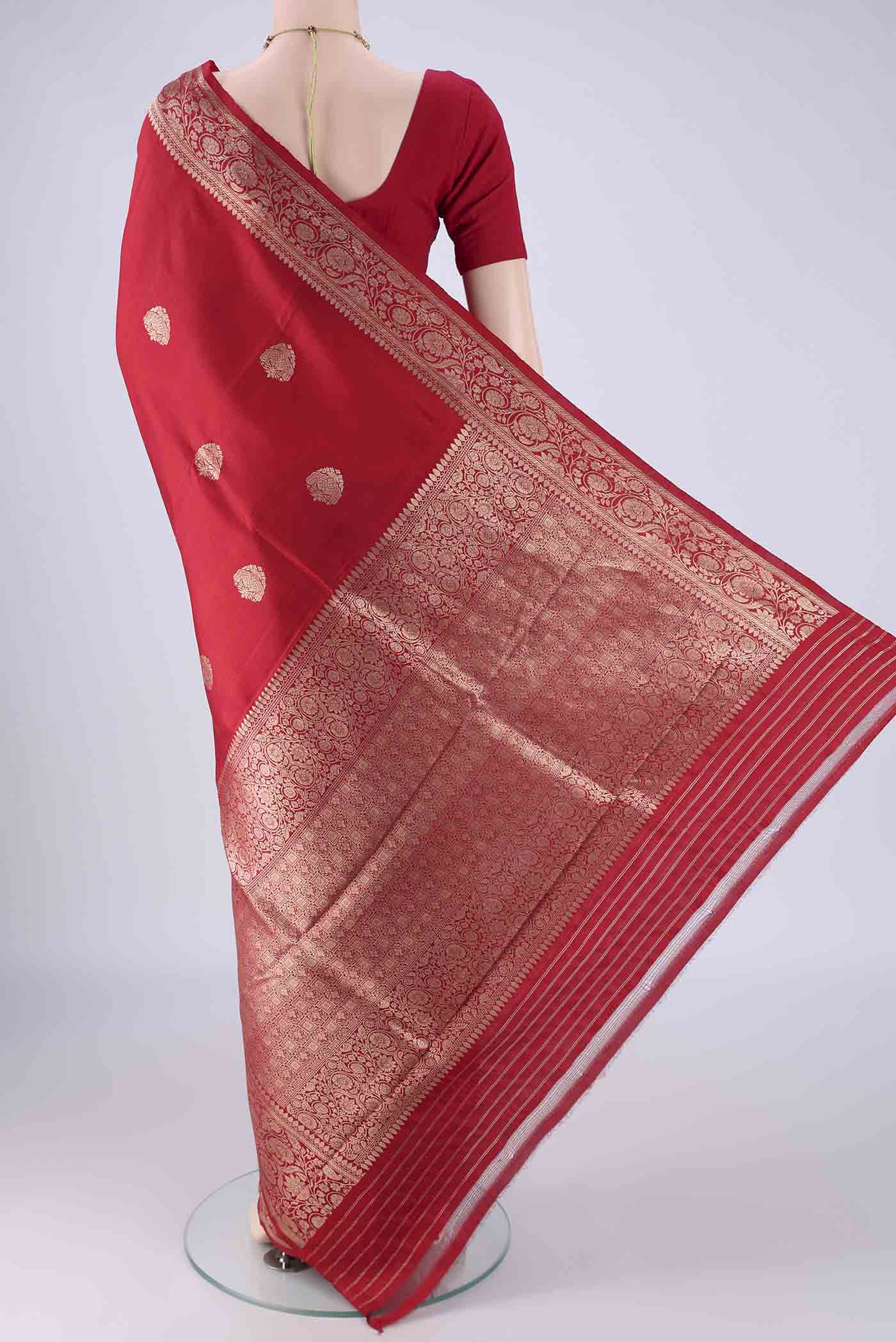 Flat view of Red Banarasi Katan Silk Saree with Zari Butta on the body and Zari Border. 