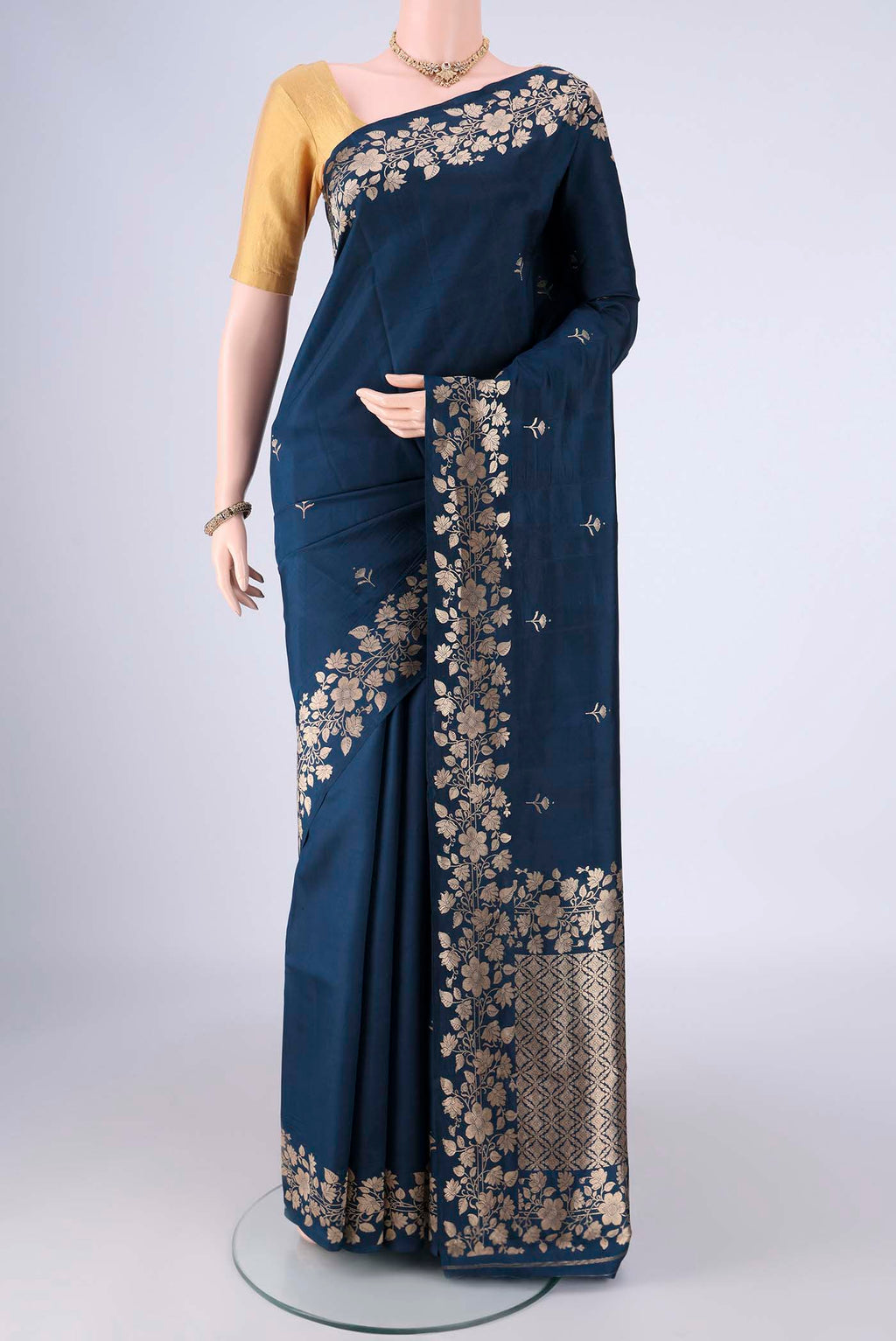 Navy Blue Banarasi Katan Silk Saree with Zari Butta on the body and Zari Border.  displayed on a mannequin