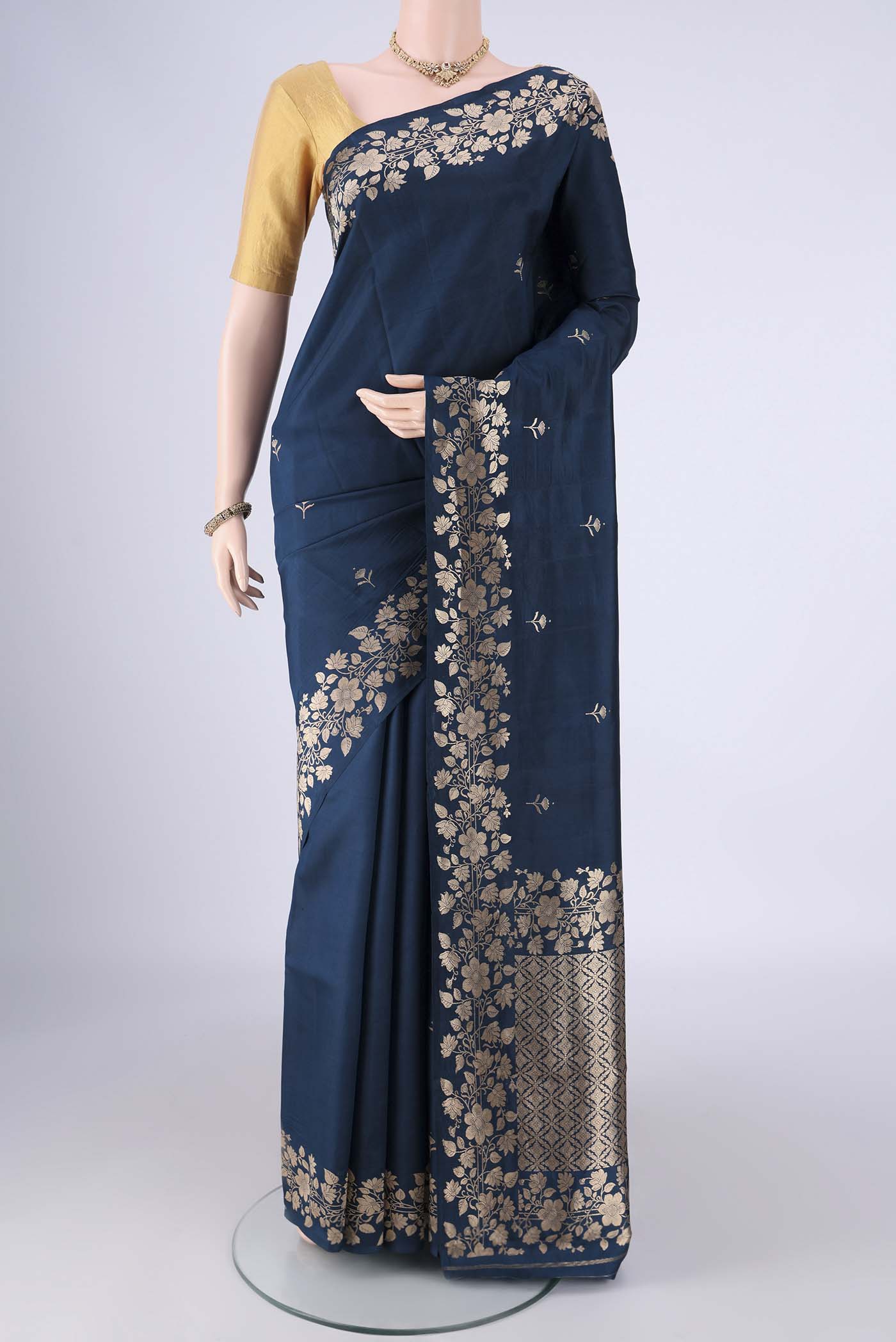 Navy Blue Banarasi Katan Silk Saree with Zari Butta on the body and Zari Border.  displayed on a mannequin