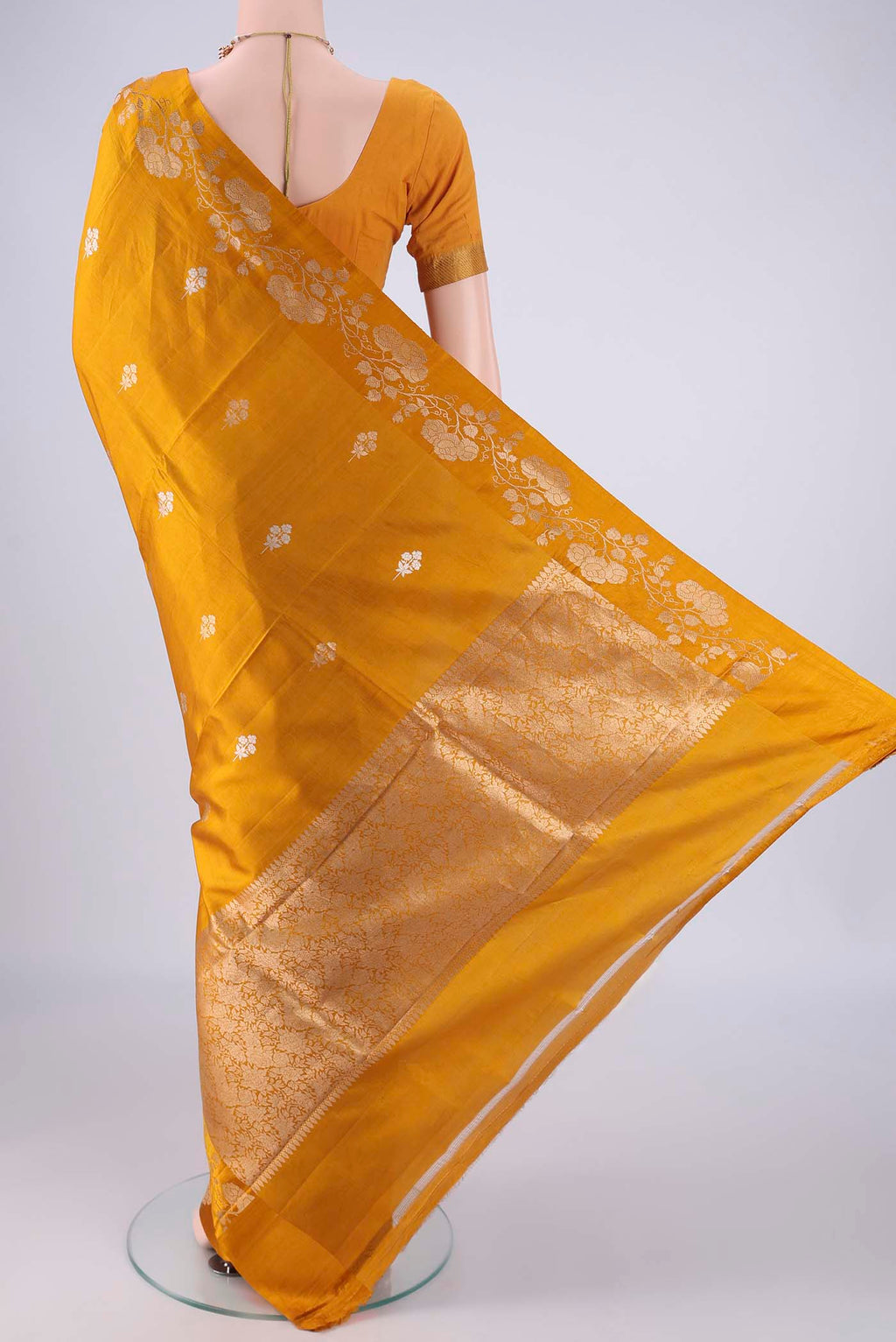 Flat view of Mustard Banarasi Katan Silk Saree with Zari Butta on the body and Zari Border. 
