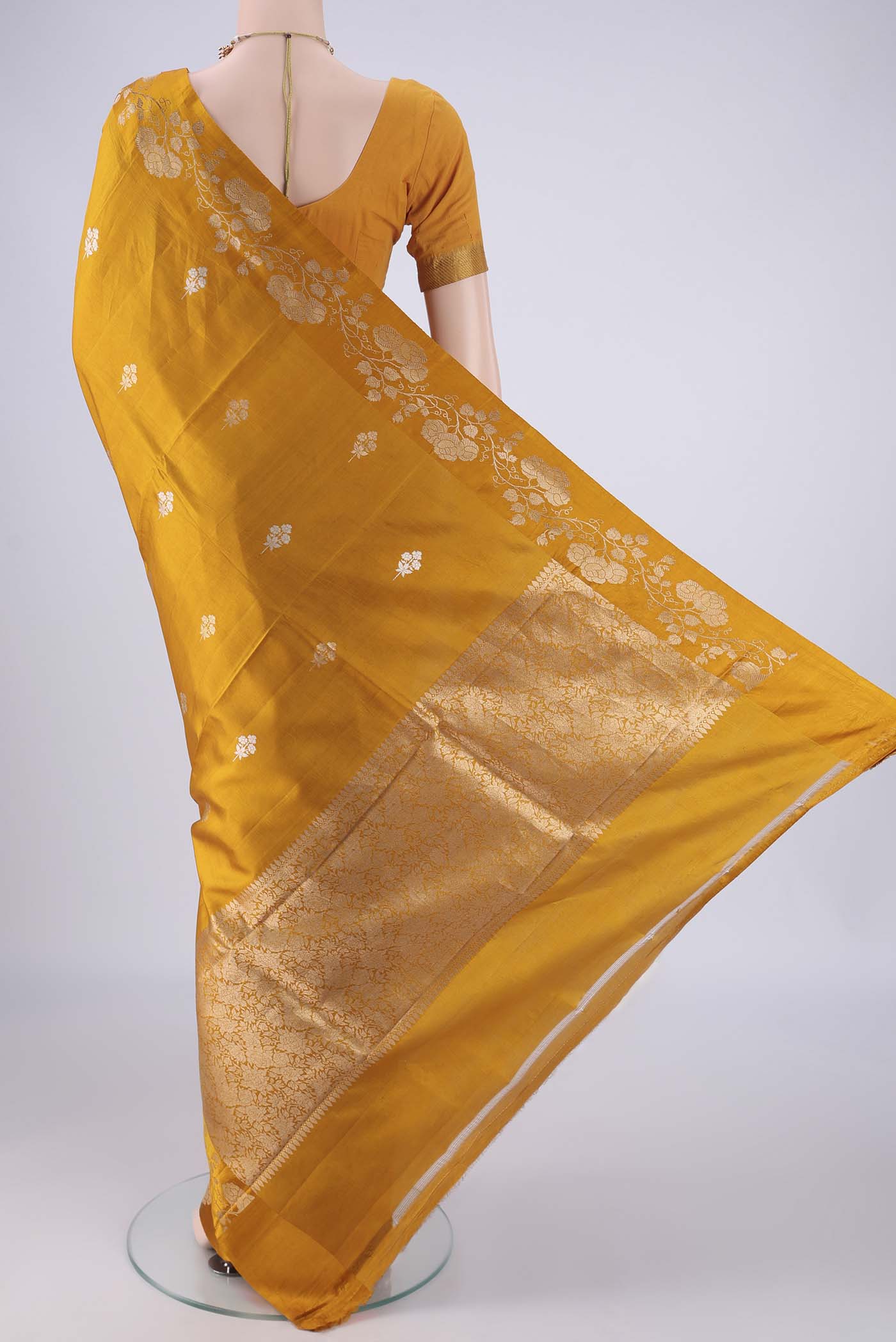 Flat view of Mustard Banarasi Katan Silk Saree with Zari Butta on the body and Zari Border. 