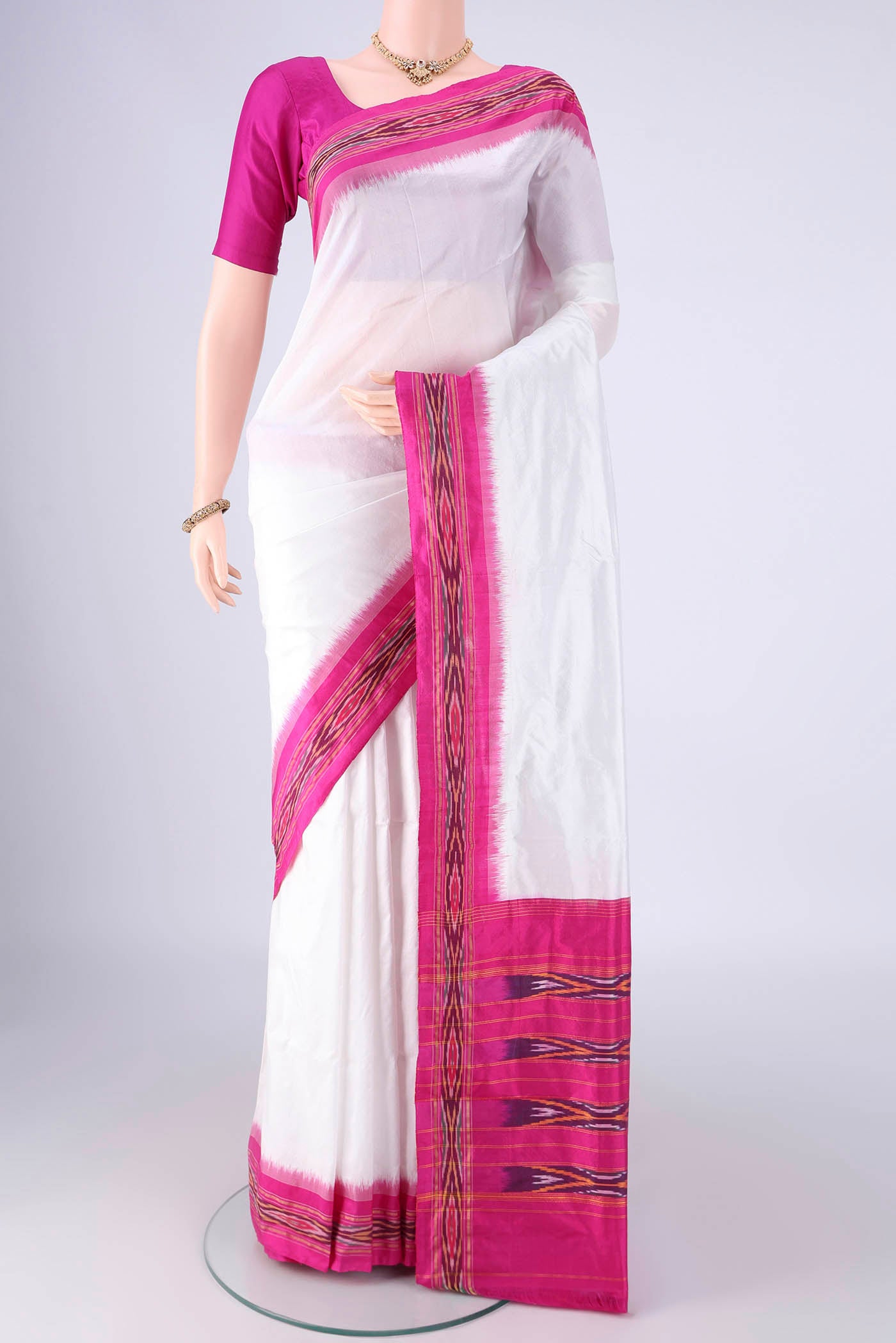 White Pochampally Silk Saree with Plain Body and Ikat Border.  displayed on a mannequin