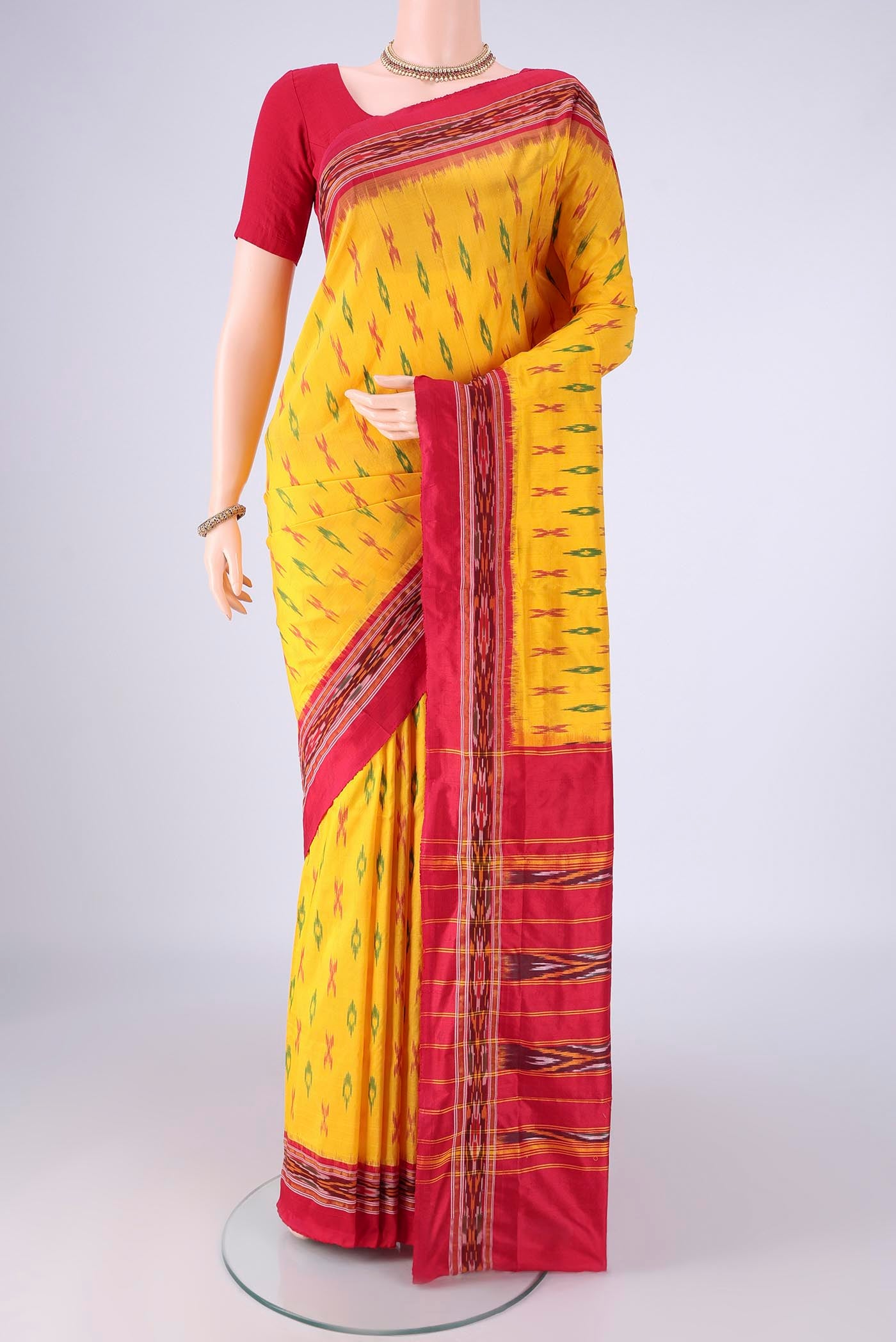 Yellow Pochampally Silk Saree with Pure Ikat on the body and Ikat Border.  displayed on a mannequin
