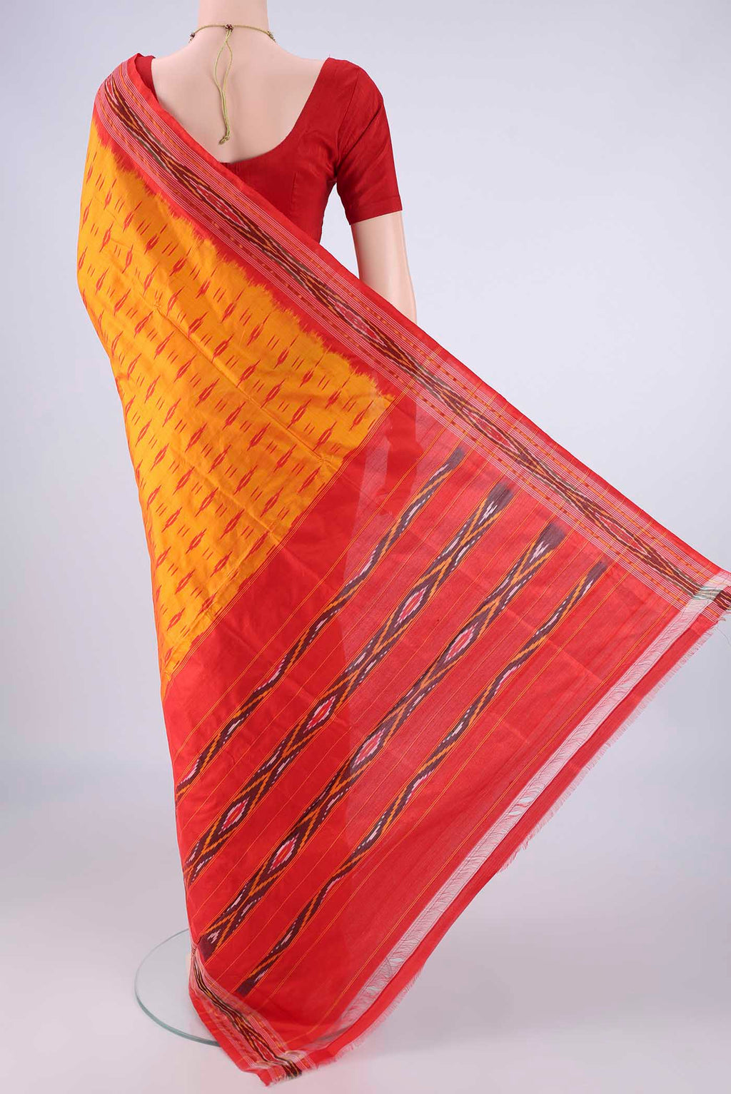 Flat view of Orange Pochampally Silk Saree with Pure Ikat on the body and Ikat Border. 