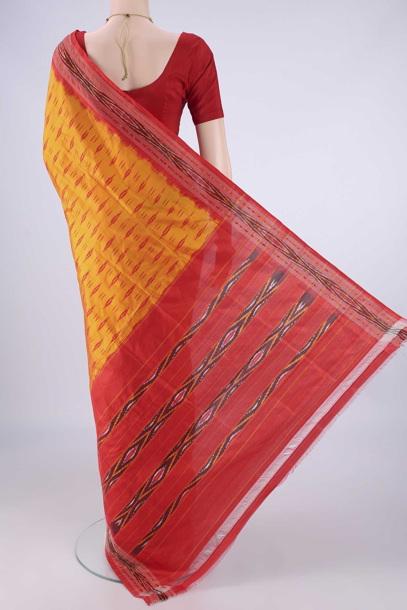 Flat view of Orange Pochampally Silk Saree with Pure Ikat on the body and Ikat Border. 