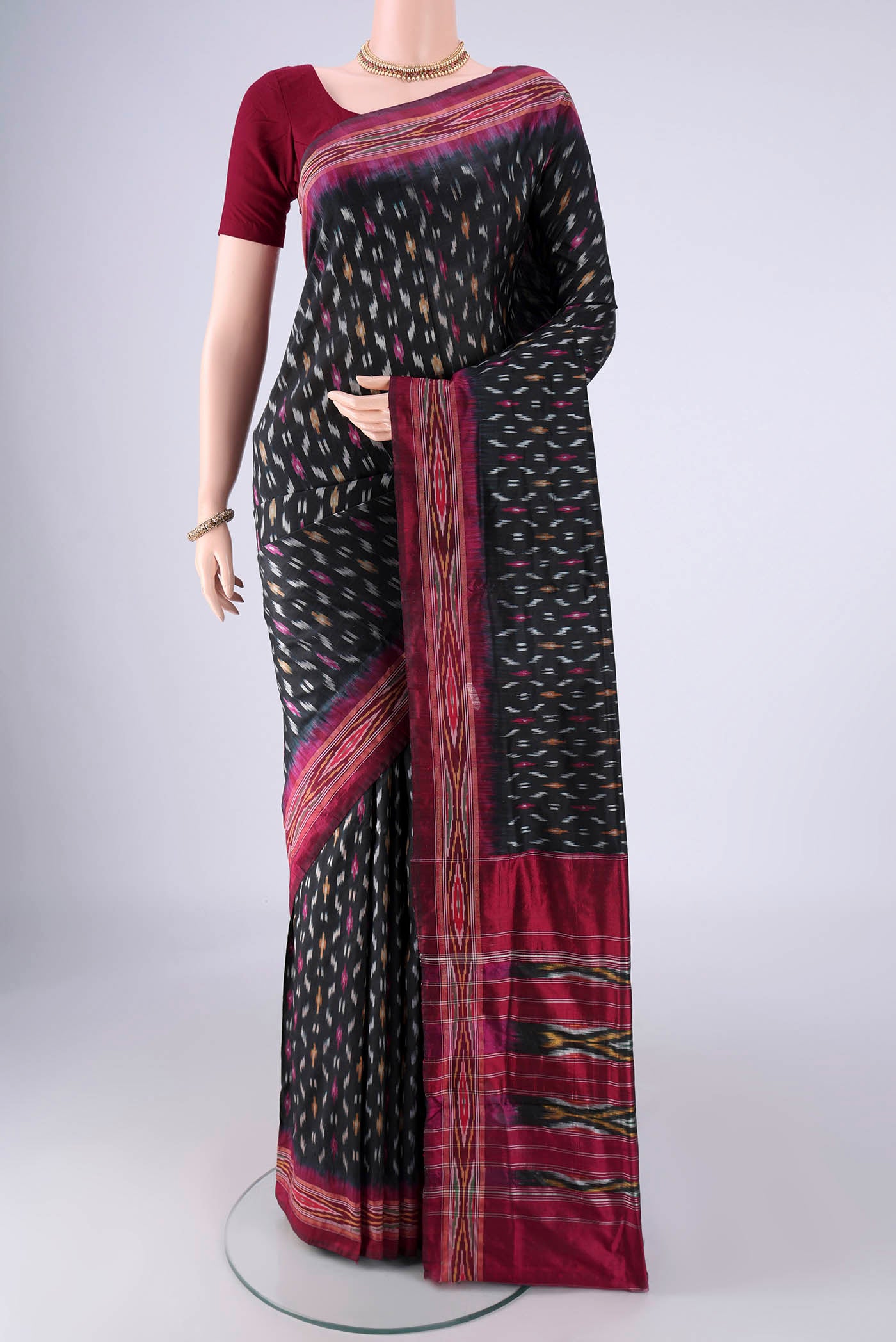 Black Pochampally Silk Saree with Pure Ikat on the body and Ikat Border.  displayed on a mannequin