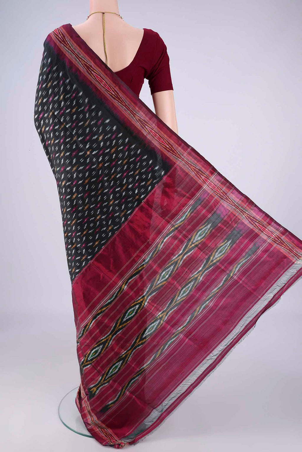 Flat view of Black Pochampally Silk Saree with Pure Ikat on the body and Ikat Border. 