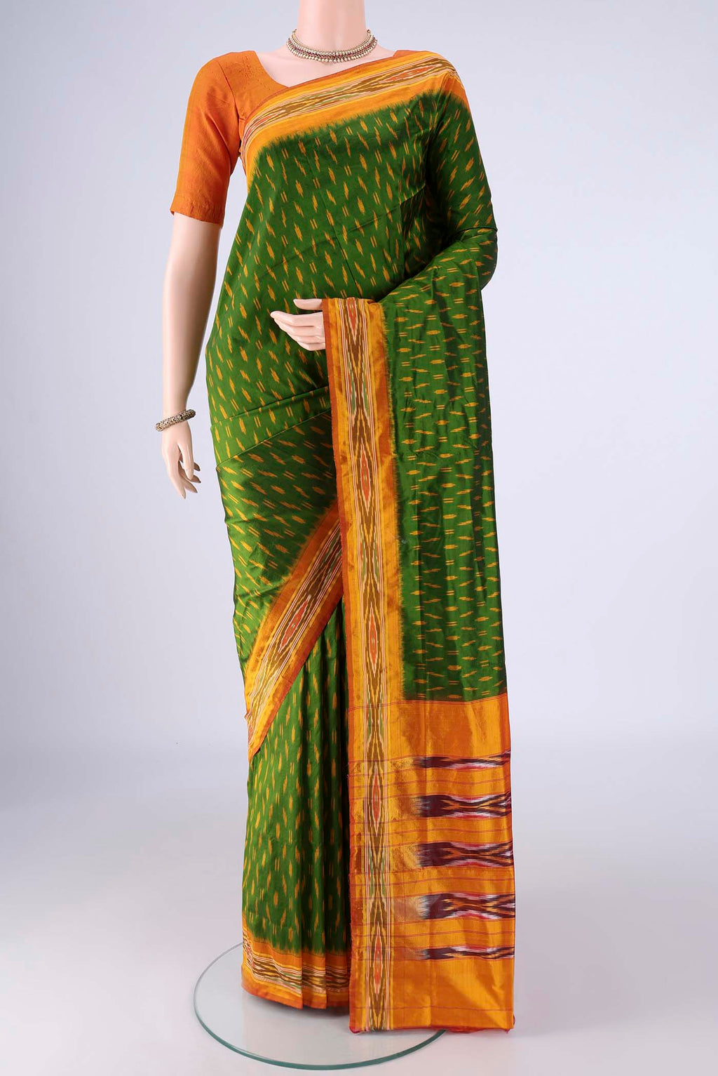 Green Pochampally Silk Saree with Pure Ikat on the body and Ikat Border.  displayed on a mannequin