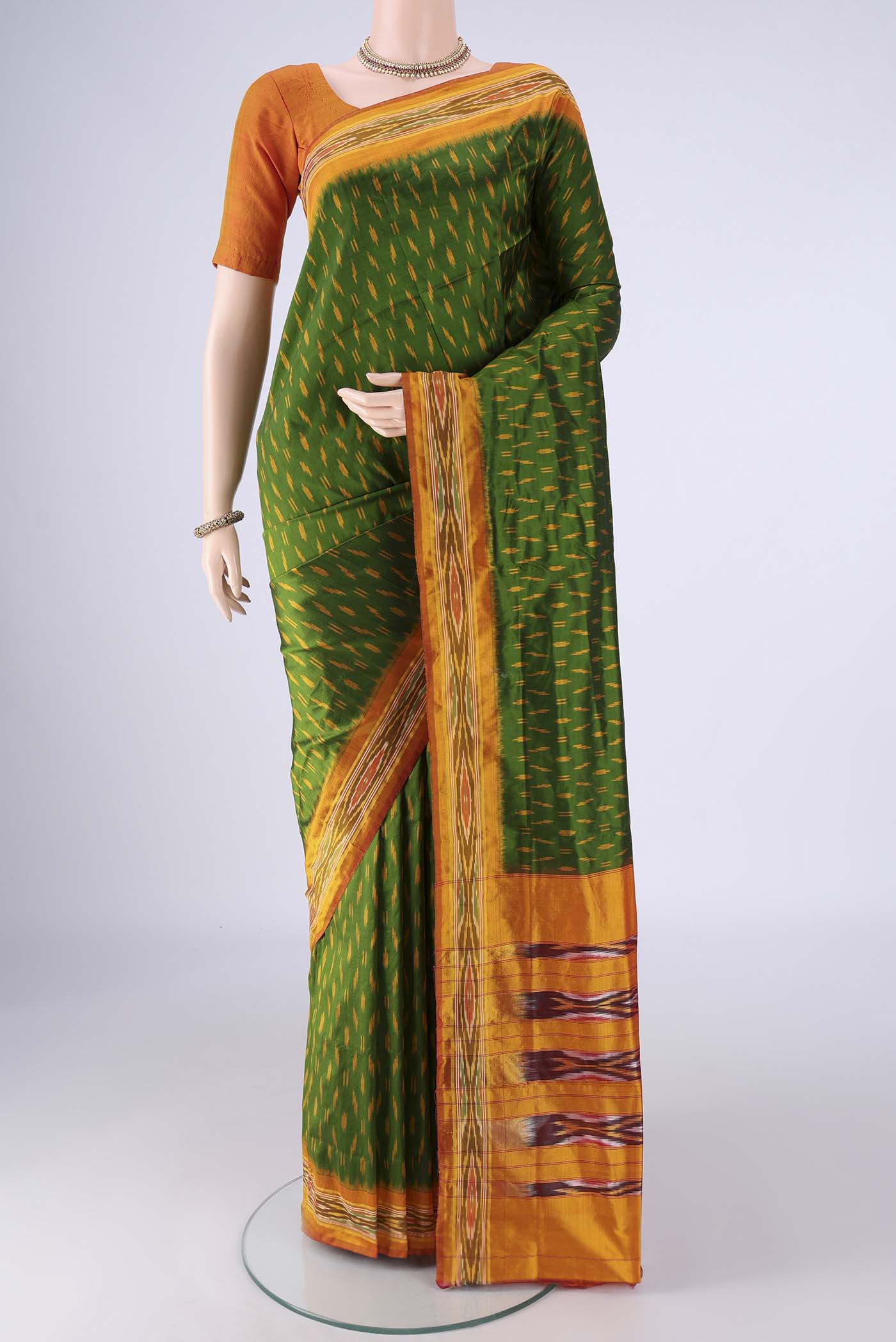 Green Pochampally Silk Saree with Pure Ikat on the body and Ikat Border.  displayed on a mannequin