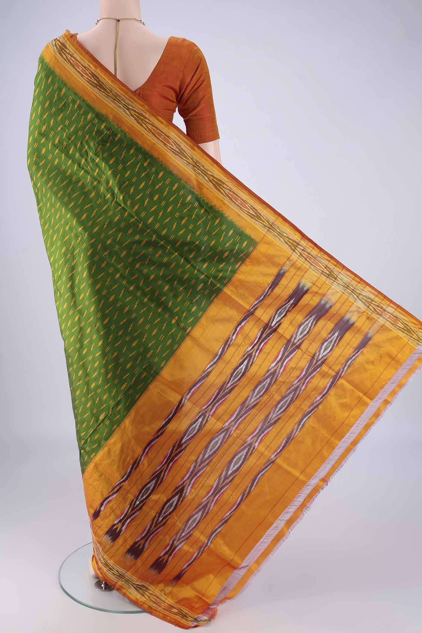 Flat view of Green Pochampally Silk Saree with Pure Ikat on the body and Ikat Border. 