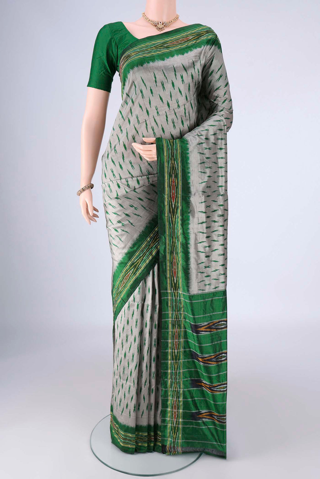 Grey Pochampally Silk Saree with Pure Ikat on the body and Ikat Border.  displayed on a mannequin