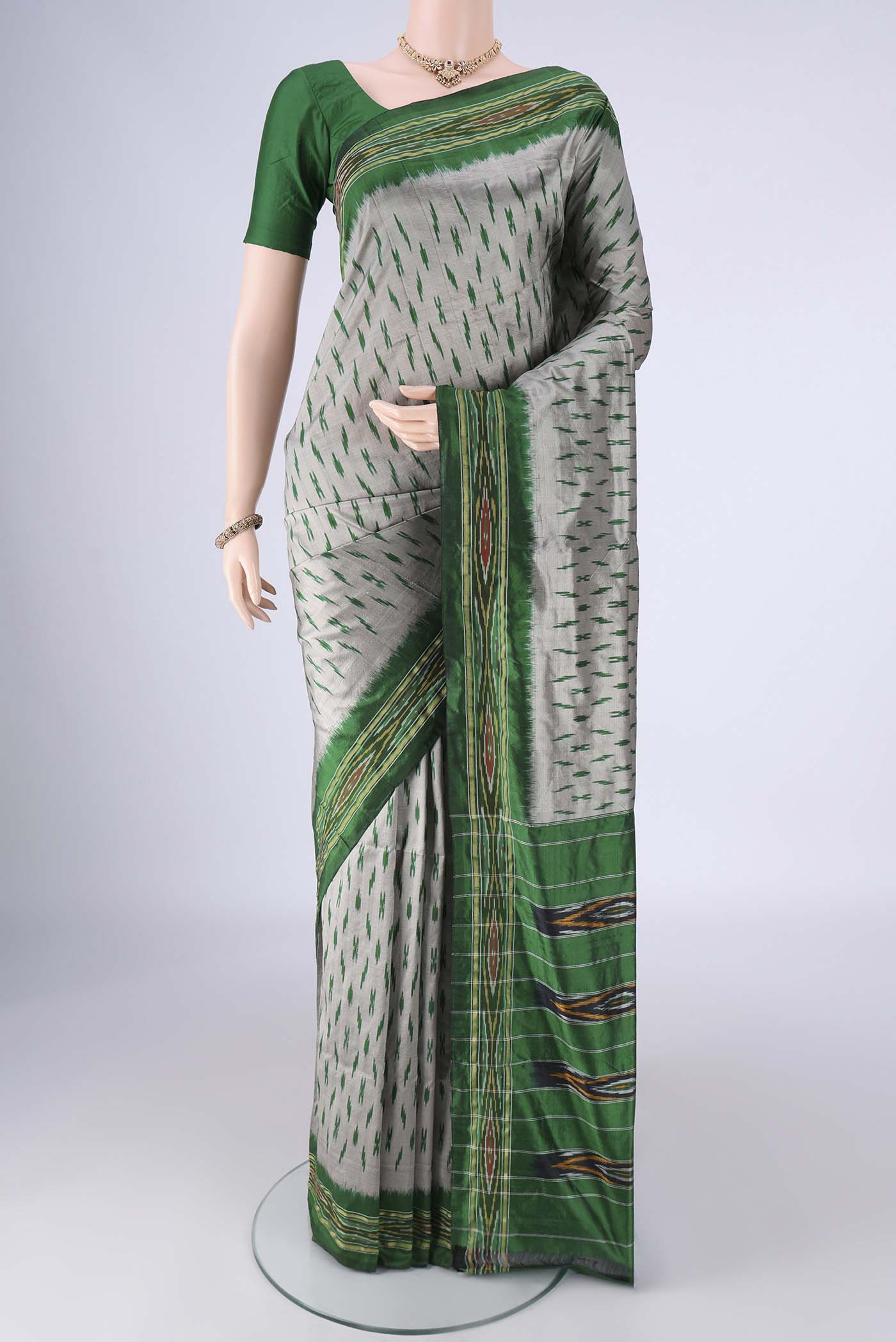Grey Pochampally Silk Saree with Pure Ikat on the body and Ikat Border.  displayed on a mannequin