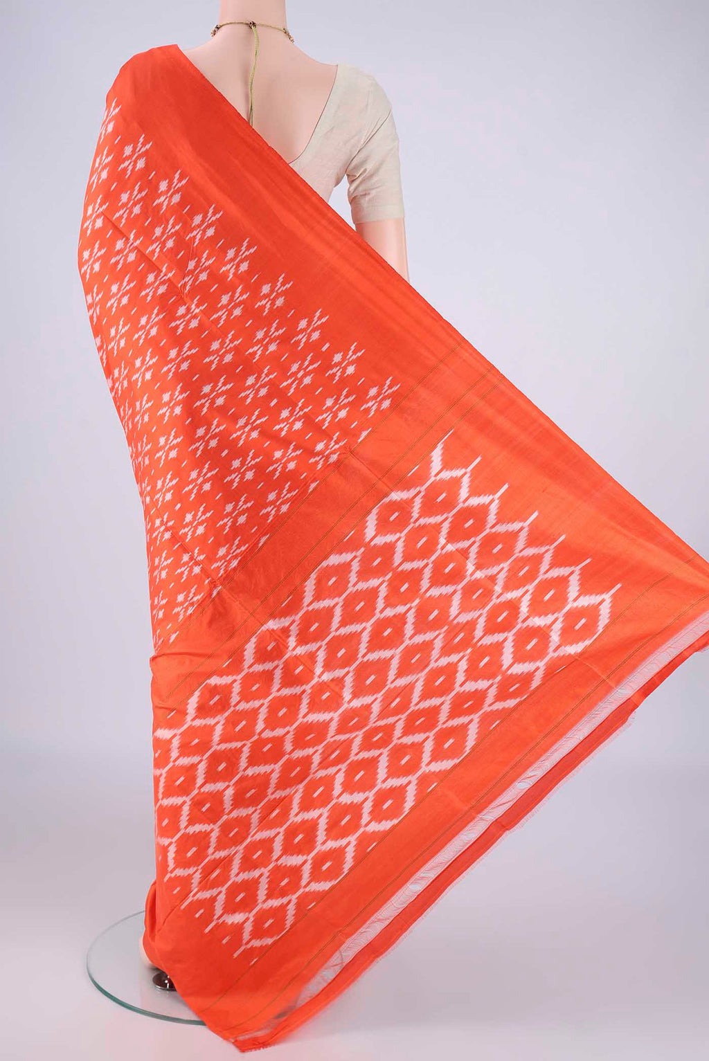 Flat view of Orange Pochampally Silk Saree with Pure Ikat on the body and Without Border. 