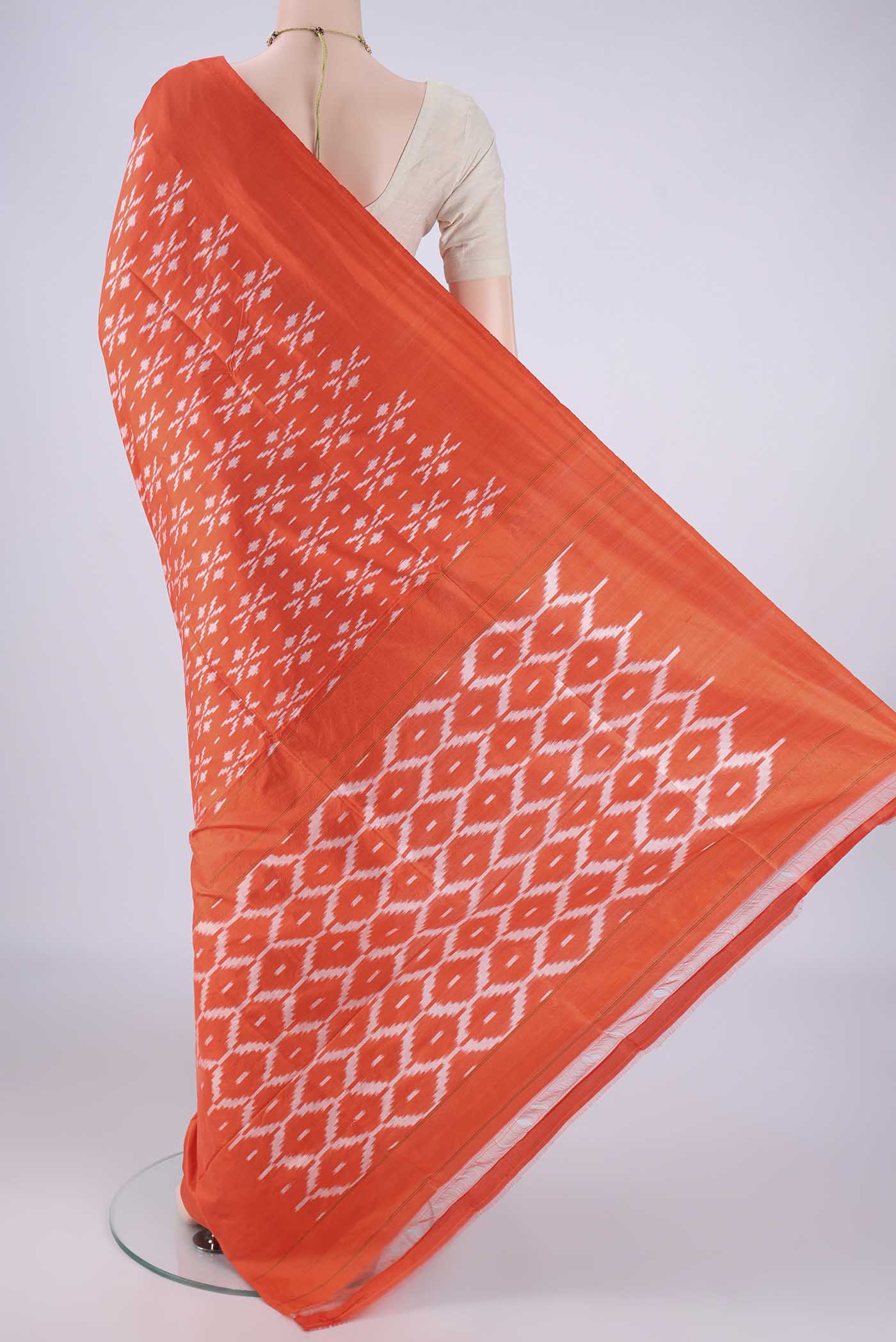 Flat view of Orange Pochampally Silk Saree with Pure Ikat on the body and Without Border. 
