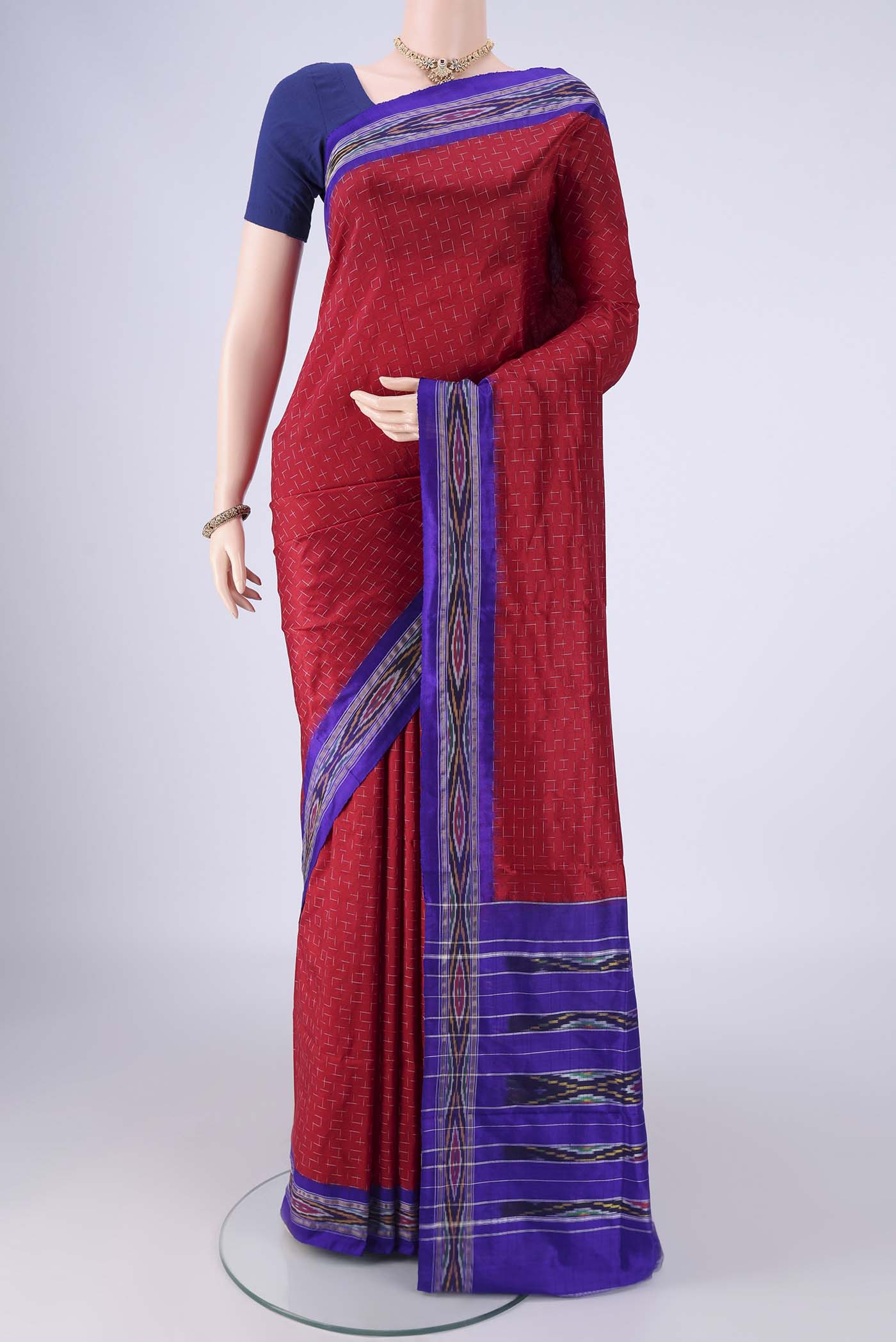 Maroon Pochampally Silk Saree with Pure Ikat on the body and Ikat Border.  displayed on a mannequin