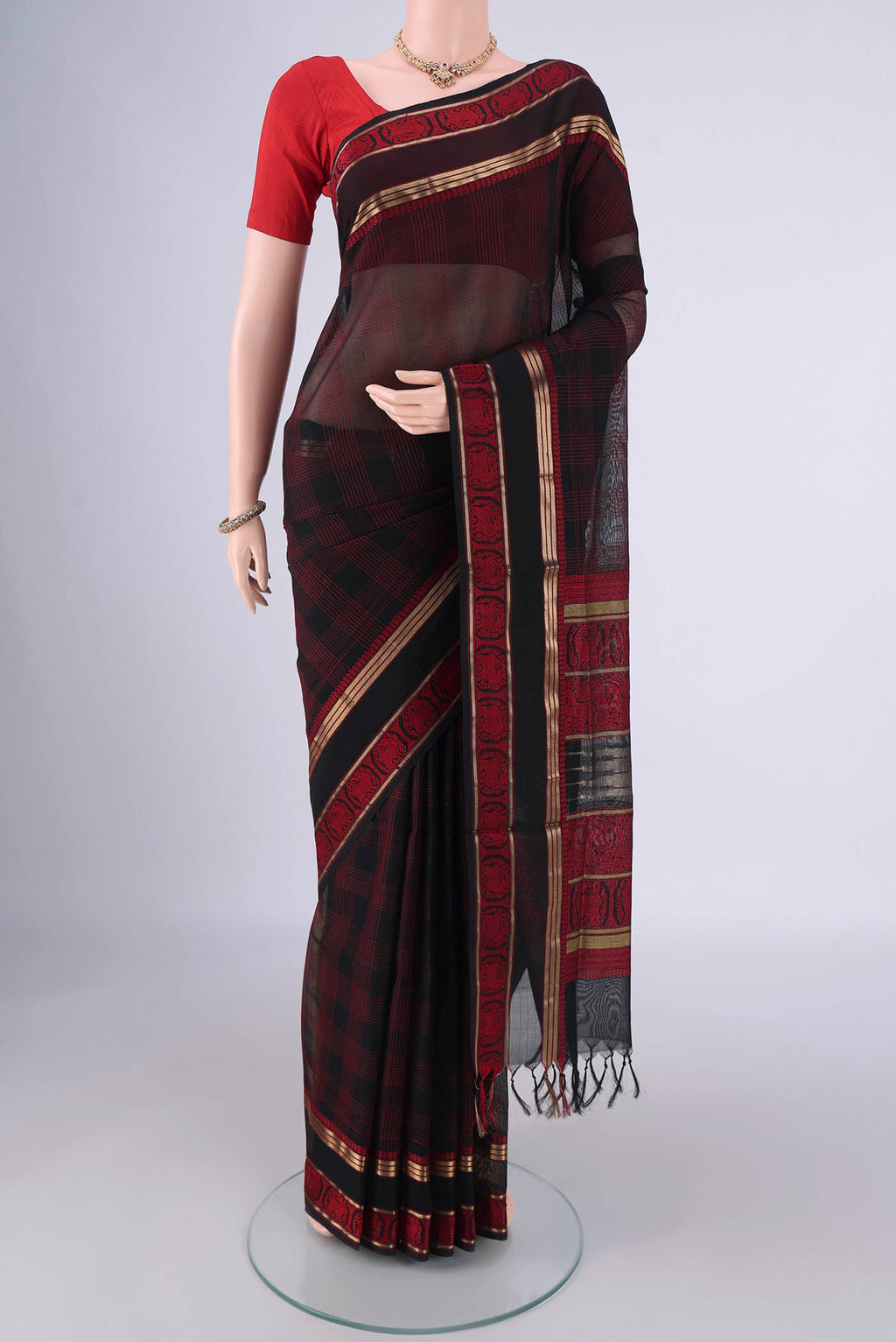 Black Blended Kanchi Cotton Saree with Checked design on the body and Zari Border.  displayed on a mannequin