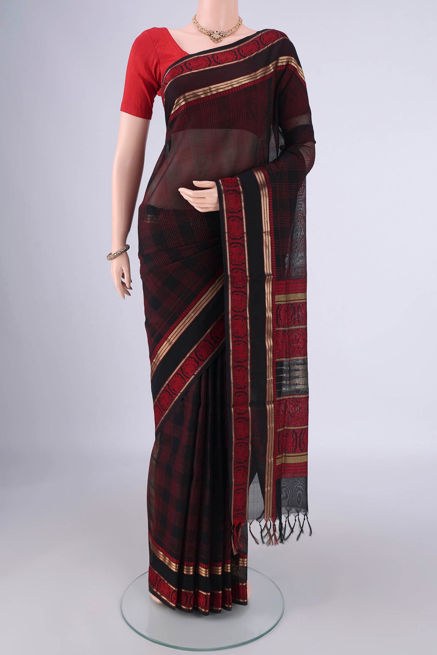 Black Blended Kanchi Cotton Saree with Checked design on the body and Zari Border.  displayed on a mannequin