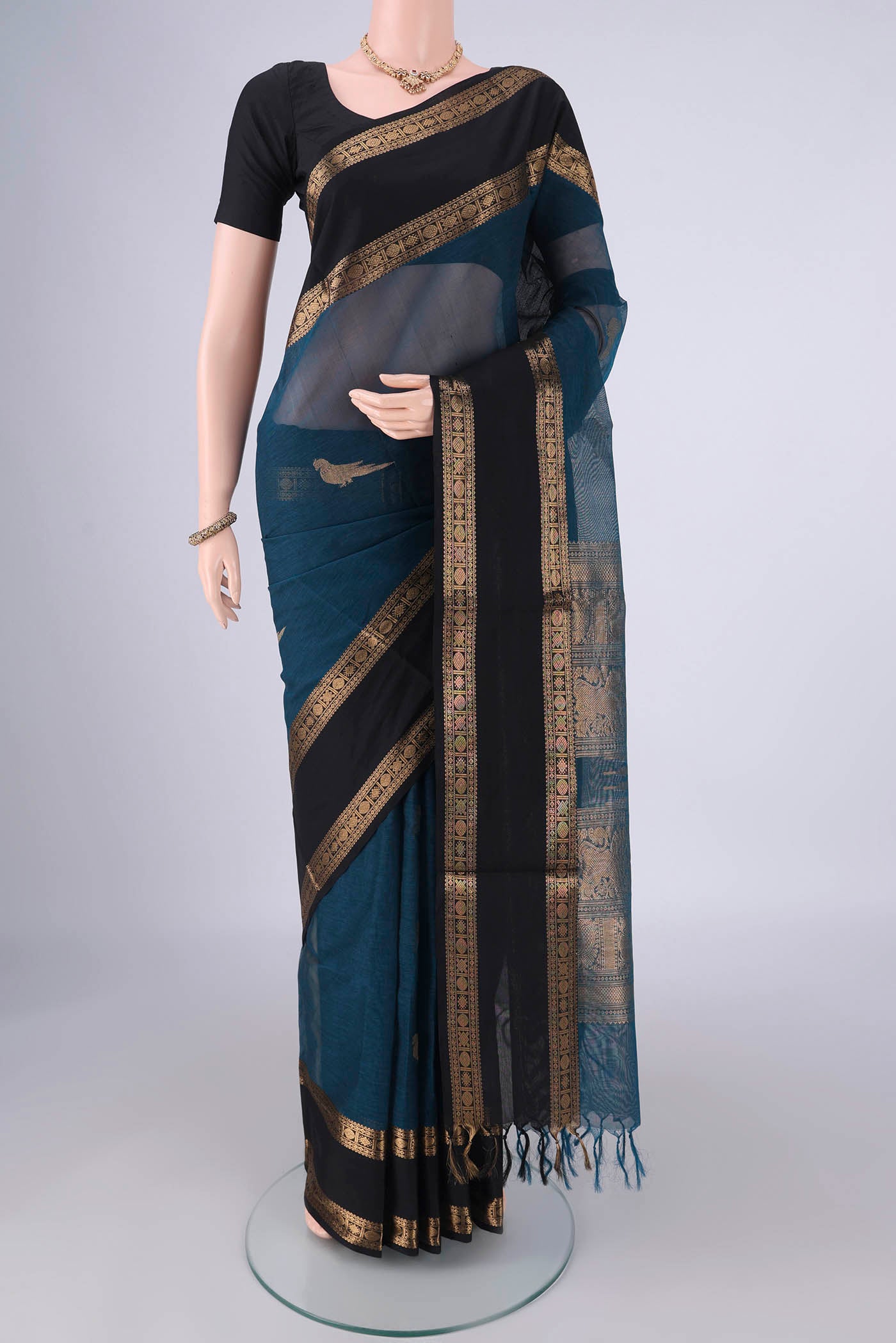 Blue Kanchi Cotton Saree with Zari Butta on the body and Zari Border.  displayed on a mannequin