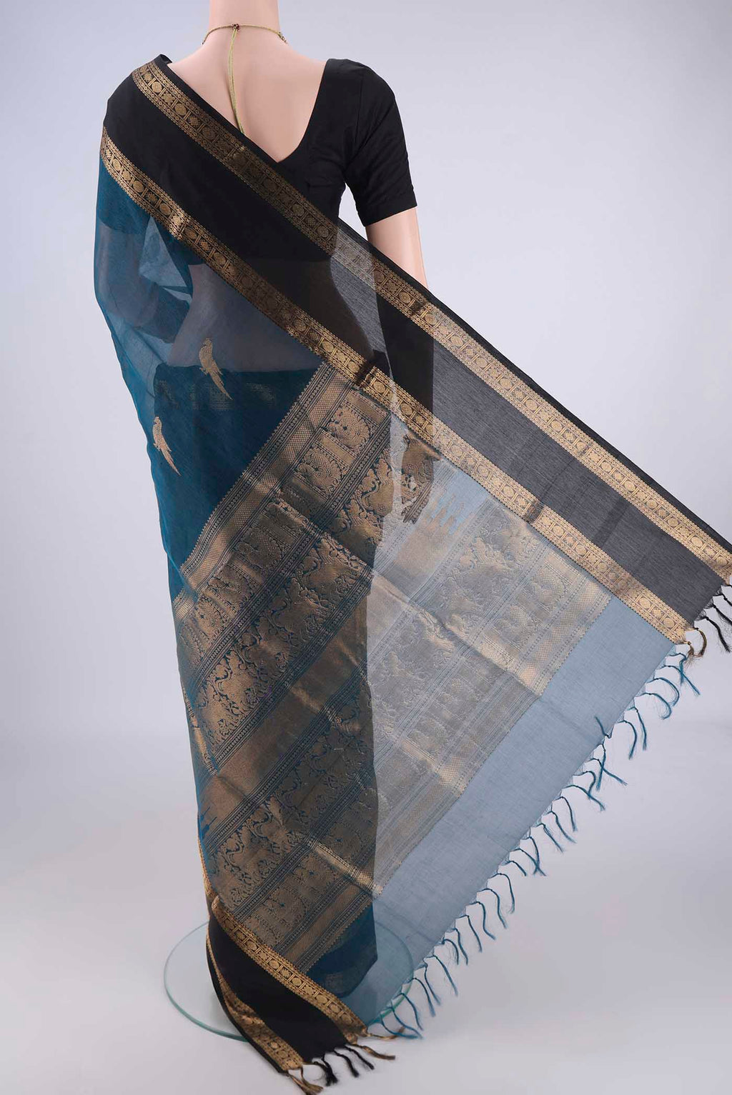 Flat view of Blue Kanchi Cotton Saree with Zari Butta on the body and Zari Border. 
