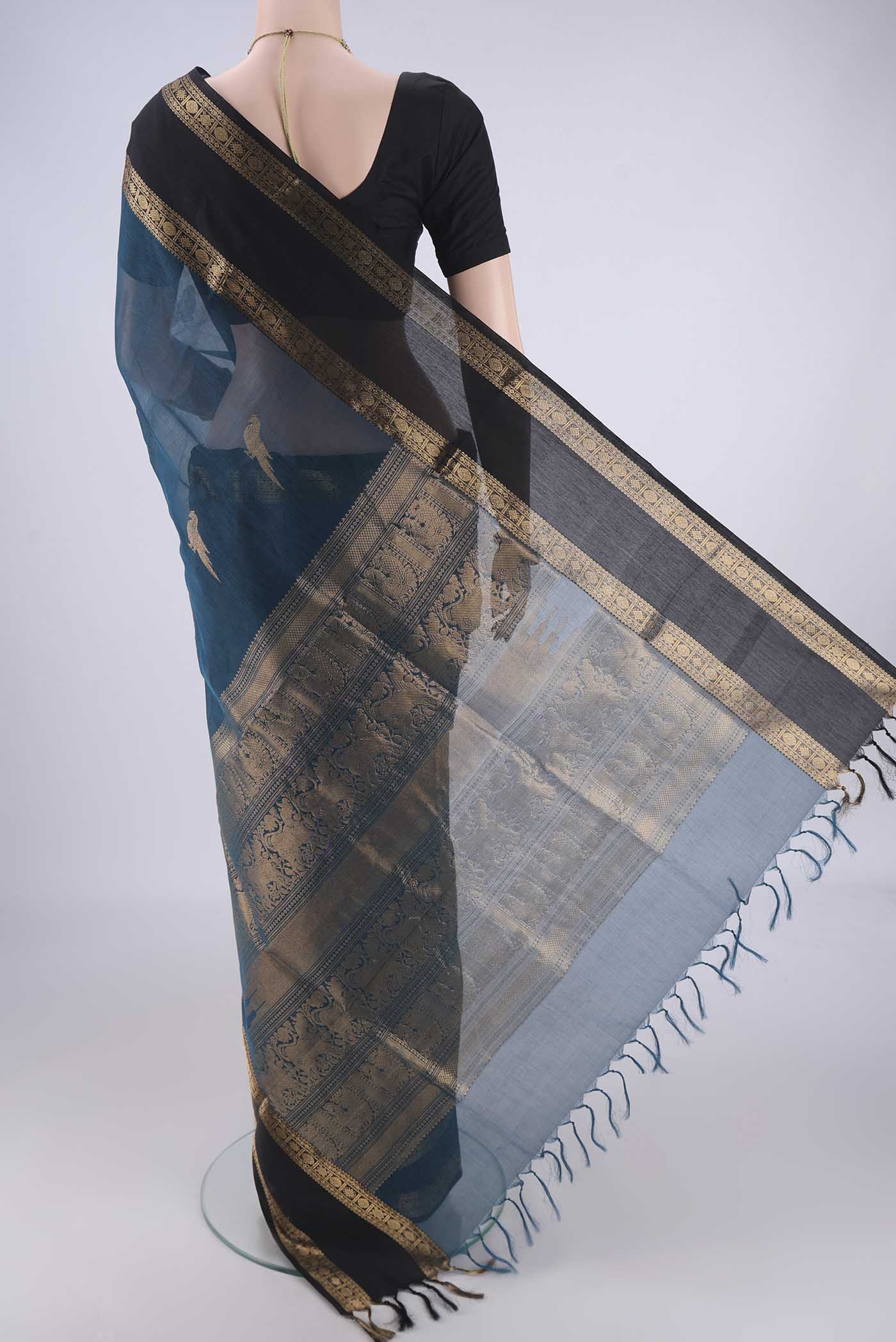 Flat view of Blue Kanchi Cotton Saree with Zari Butta on the body and Zari Border. 