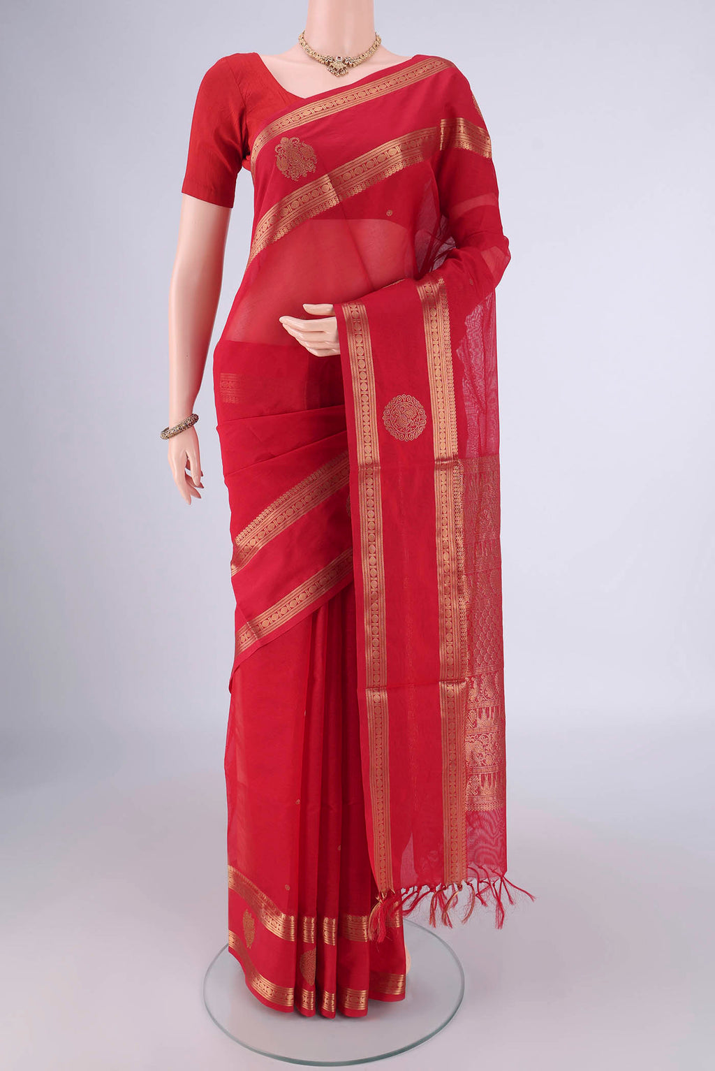 Red Kanchi Cotton Saree with Zari Butta on the body and Zari Border.  displayed on a mannequin