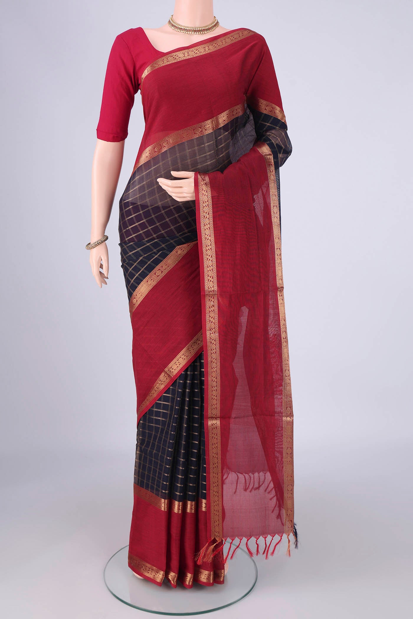 Navy Blue Coimbatore Silk Cotton Saree with Checked design on the body and Zari Border.  displayed on a mannequin