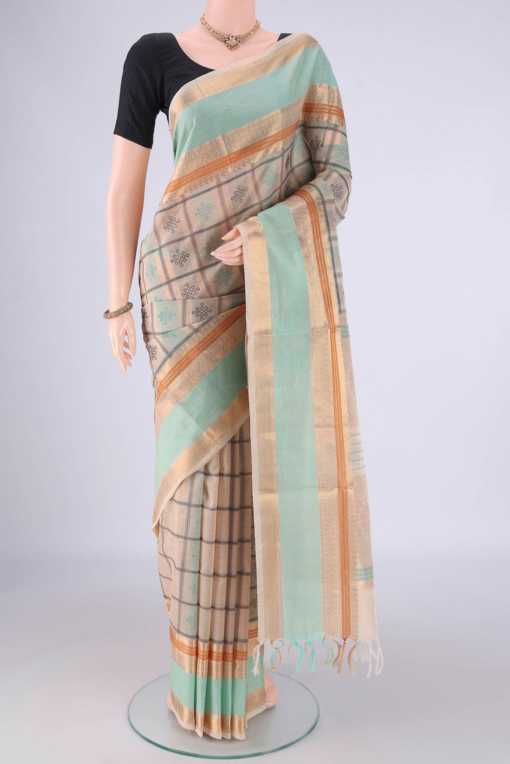 Beige Coimbatore Silk Cotton Saree with Checked design on the body and Zari Border.  displayed on a mannequin
