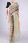 Beige Coimbatore Silk Cotton Saree with Checked design on the body and Zari Border.  displayed on a mannequin