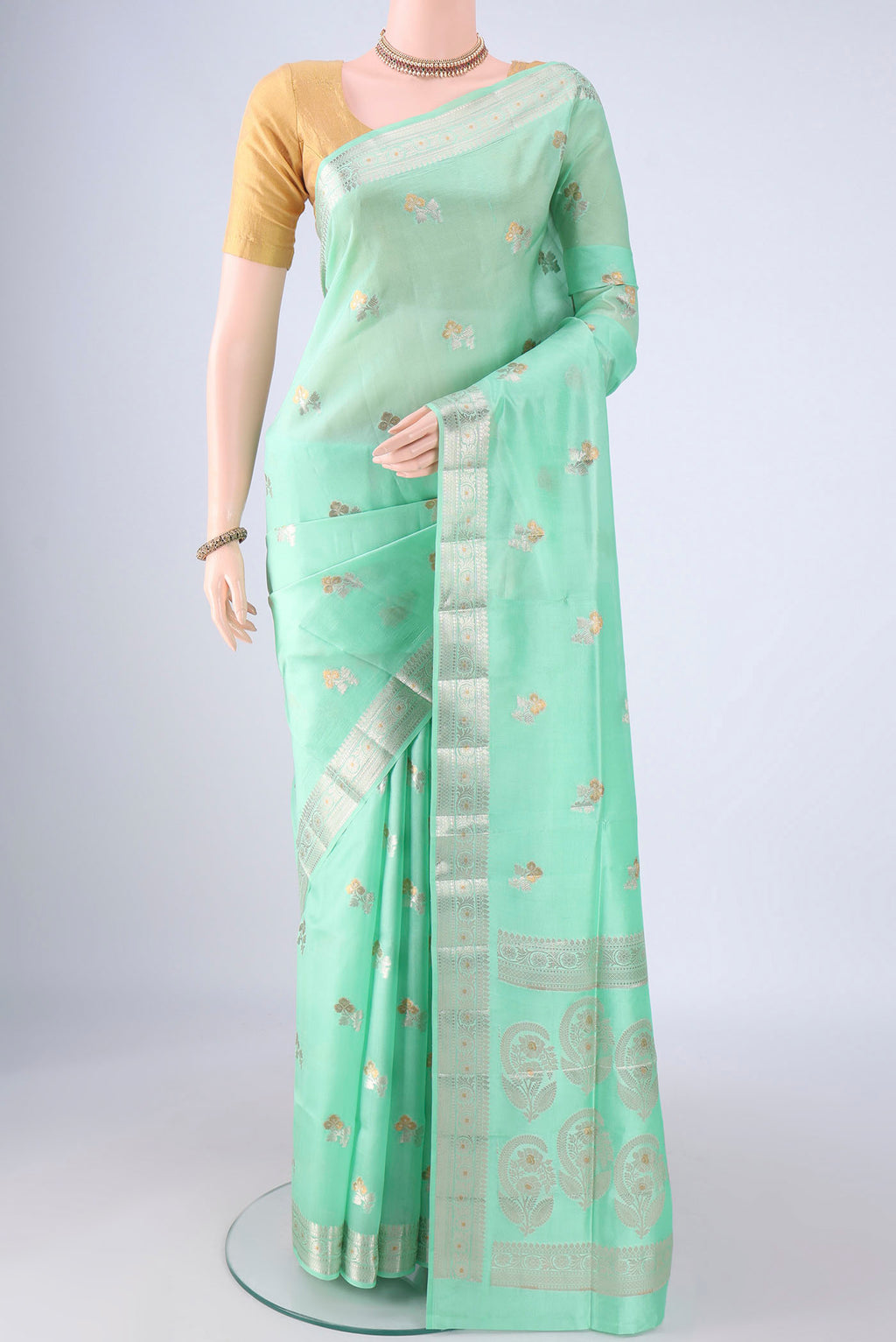 Sea Green Banarasi Tussar Silk Saree with Zari And Thread Butta on the body and Zari Border.  displayed on a mannequin