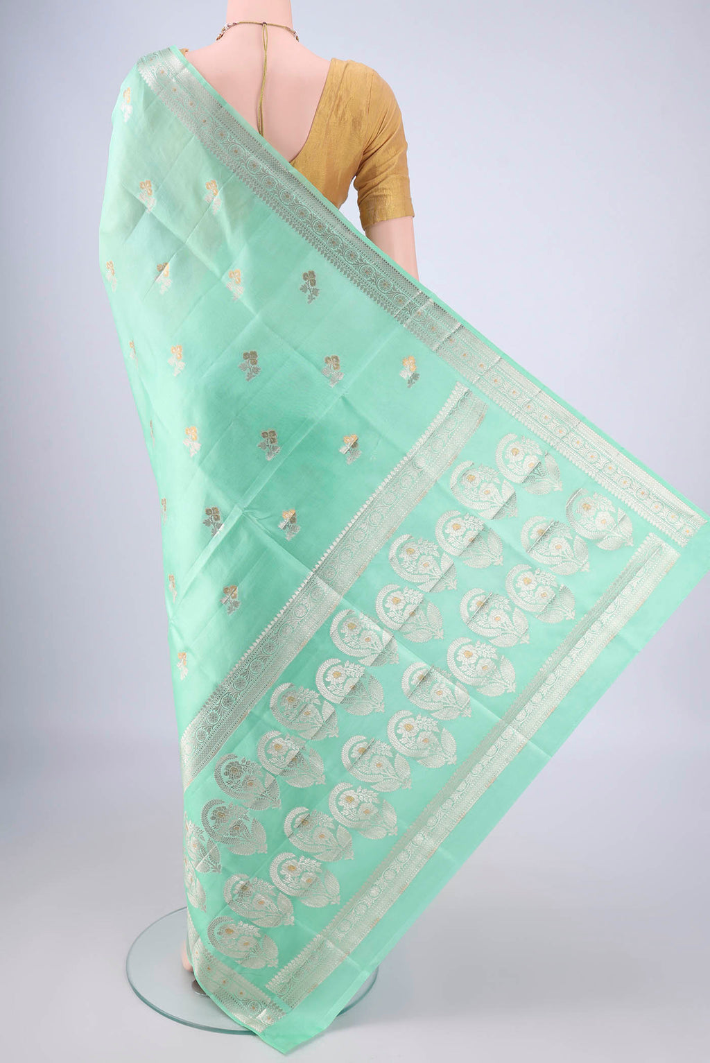 Flat view of Sea Green Banarasi Tussar Silk Saree with Zari And Thread Butta on the body and Zari Border. 